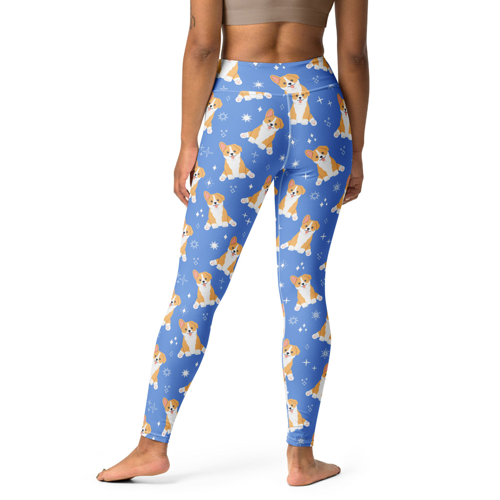 Person wearing blue leggings with corgi dog pattern on a white background
