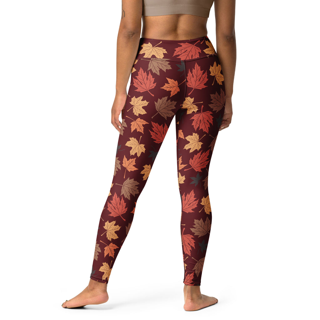 Women’s maroon buttery soft yoga leggings with vibrant orange red and brown autumn maple leaf pattern