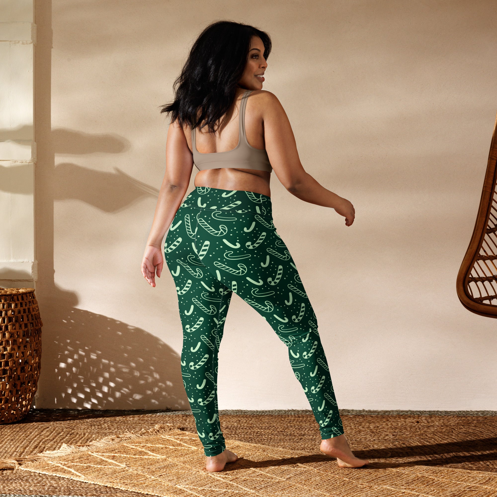 Women’s green buttery soft yoga leggings with festive white candy cane and dot pattern for Christmas wear