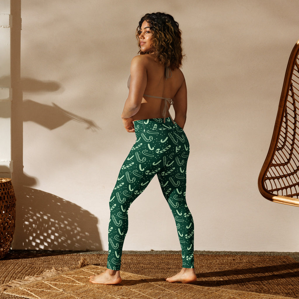 Women’s green buttery soft yoga leggings with festive white candy cane and snowflake pattern for Christmas wear