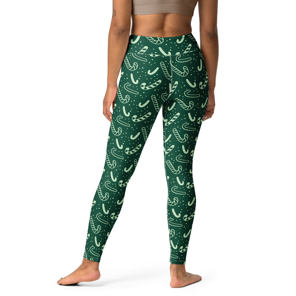 Women’s green buttery soft high-waisted yoga leggings with white candy cane and dot pattern for christmas wear