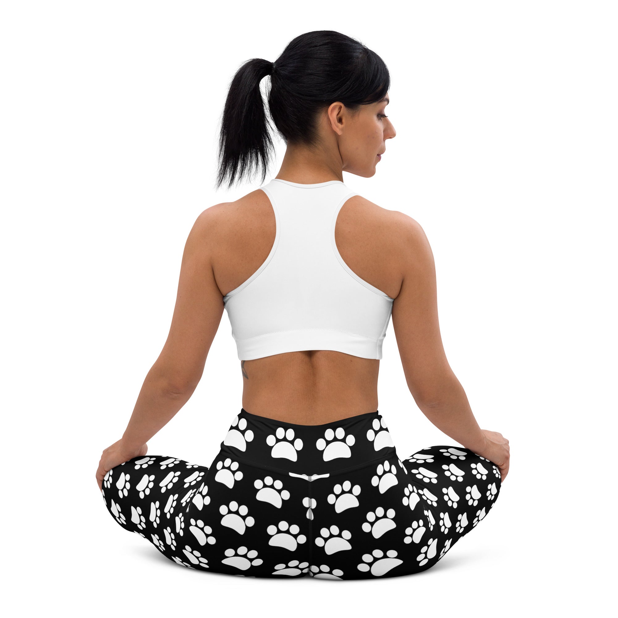 Women’s black and white paw print buttery soft yoga leggings featuring a playful white paw pattern