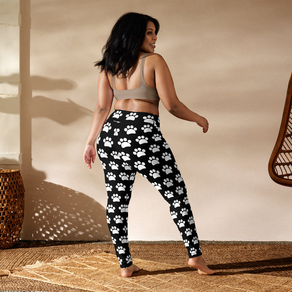 Women’s black and white paw print buttery soft yoga leggings with a repeating pattern of white paw prints
