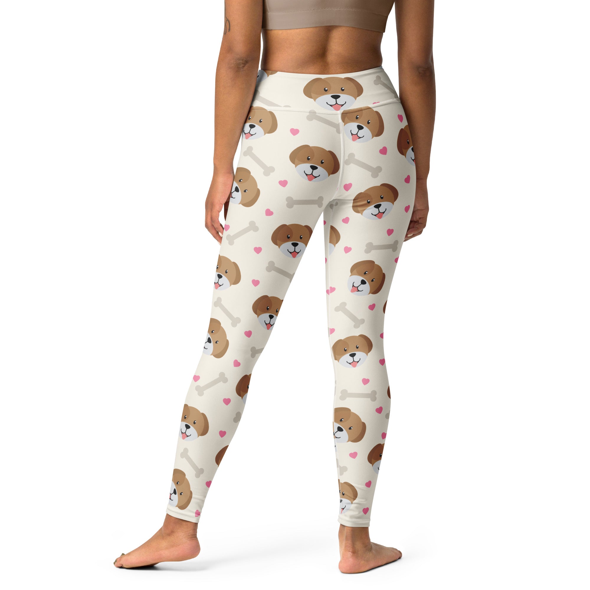Cream-colored buttery soft women’s yoga leggings with playful brown dog faces pink hearts and white bones print