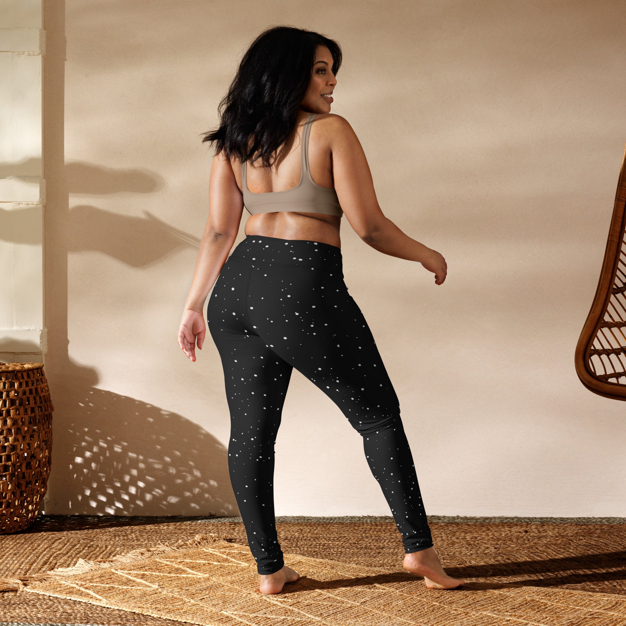 Women’s black snowflake buttery soft yoga leggings with subtle white star pattern made of stretchy fabric