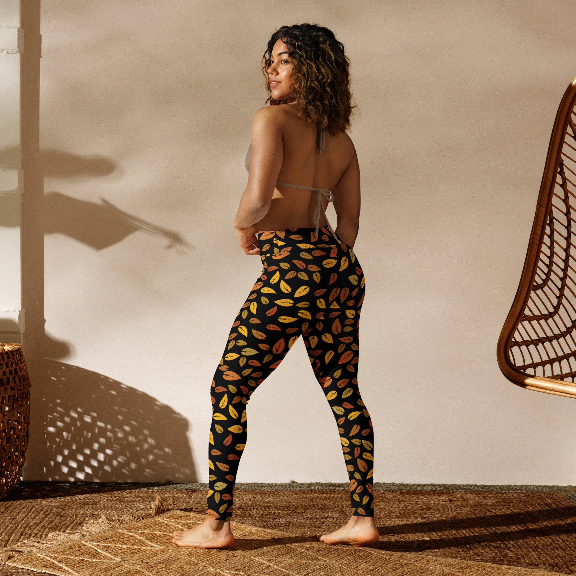 Women’s gold leaves buttery soft yoga leggings in black with a vibrant yellow orange and brown leaf pattern