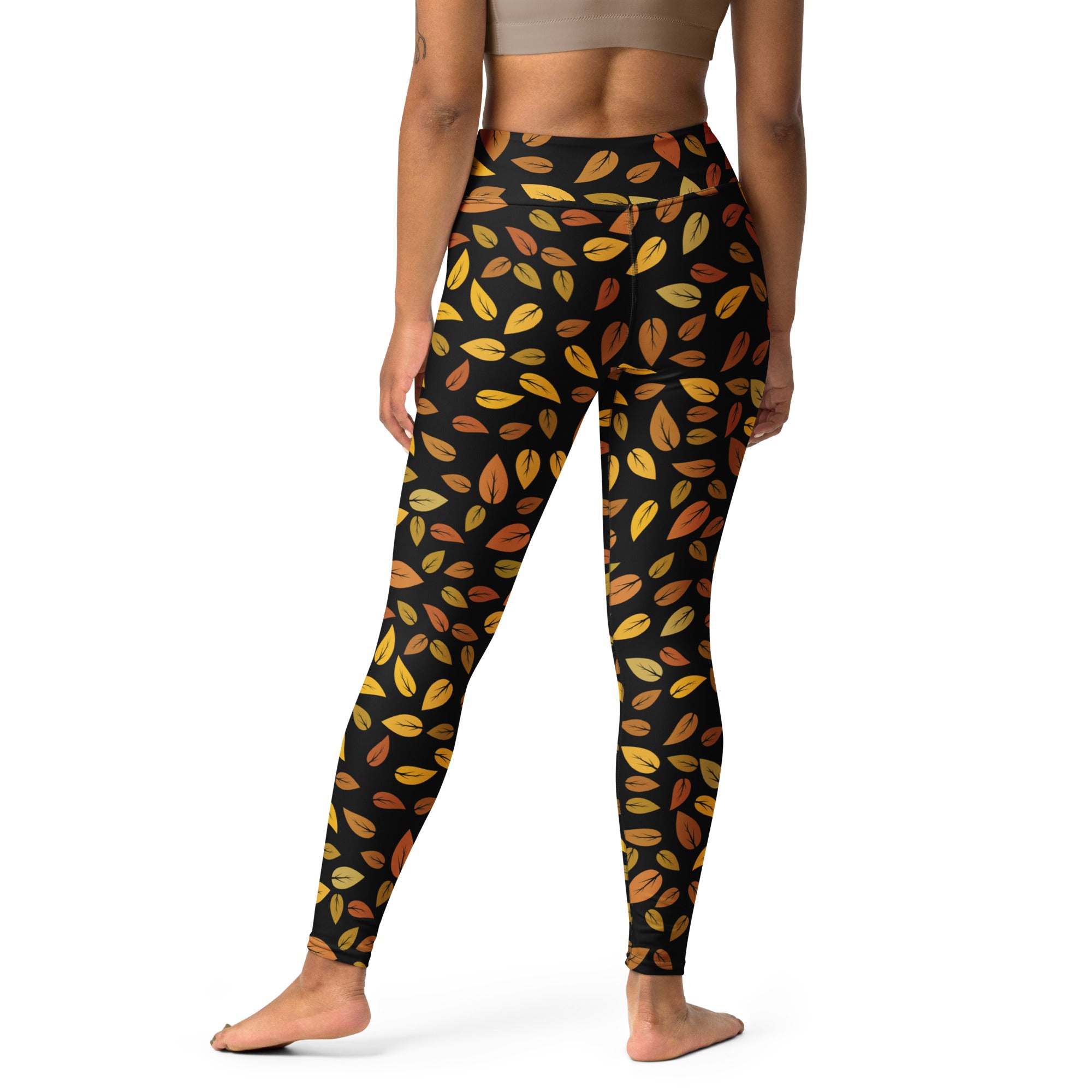Women’s gold leaves buttery soft yoga leggings in black with a vibrant yellow and orange autumn leaf pattern