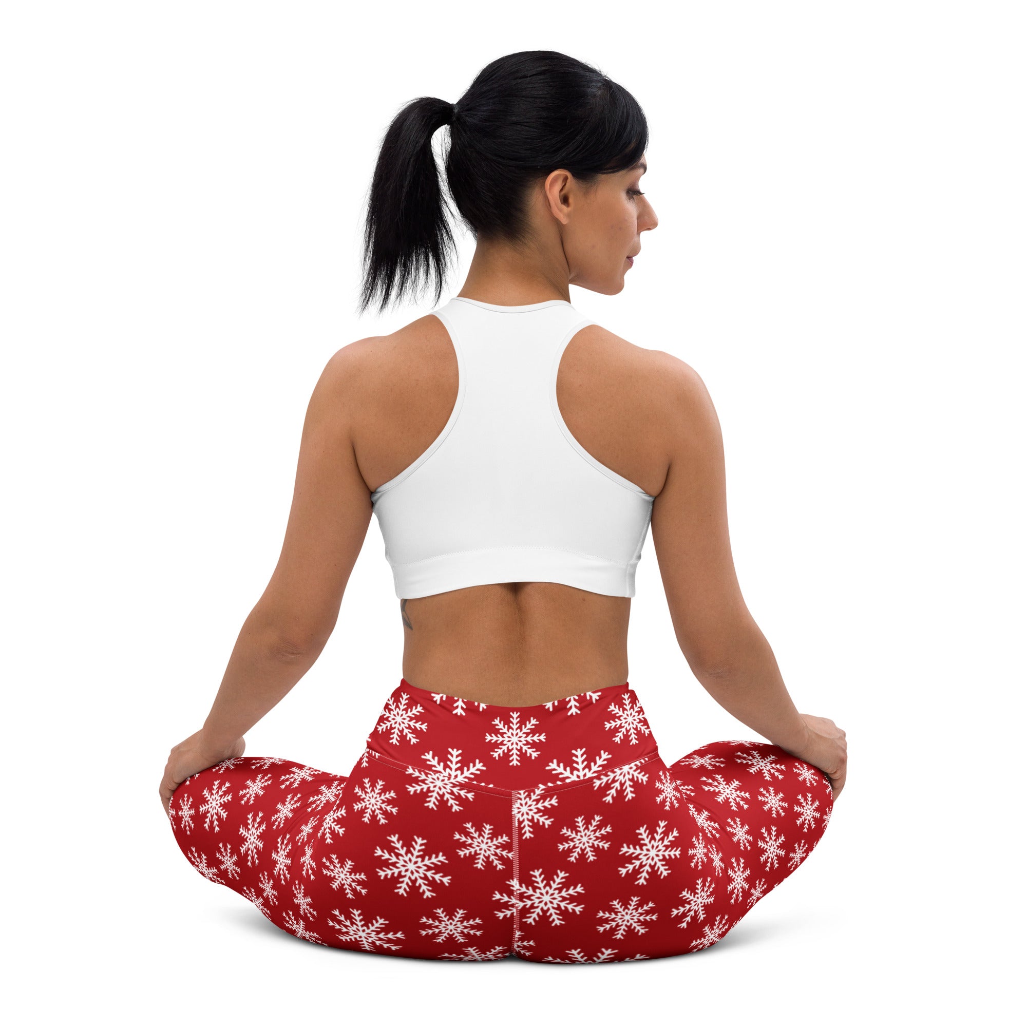 Women’s red buttery soft yoga leggings featuring a white snowflake pattern ideal for winter workouts