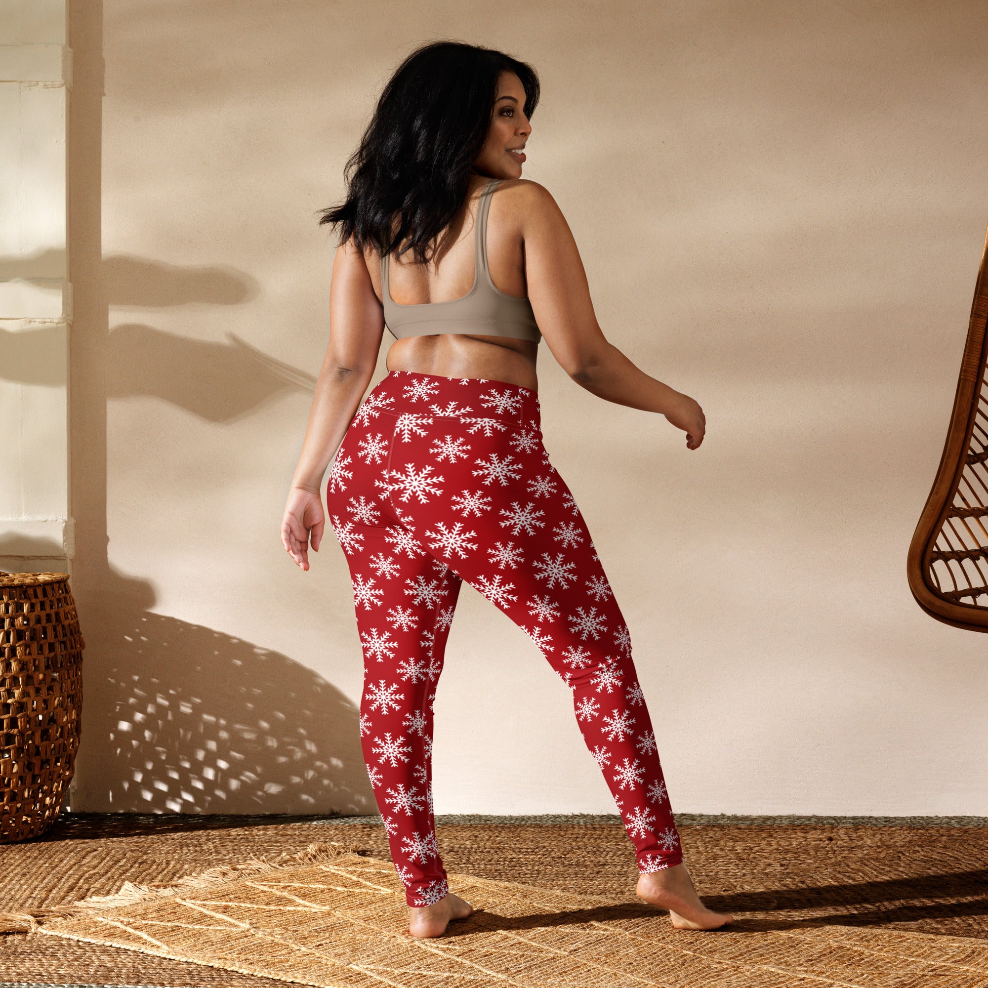 Women’s red buttery soft yoga leggings featuring a white snowflake pattern for winter workouts