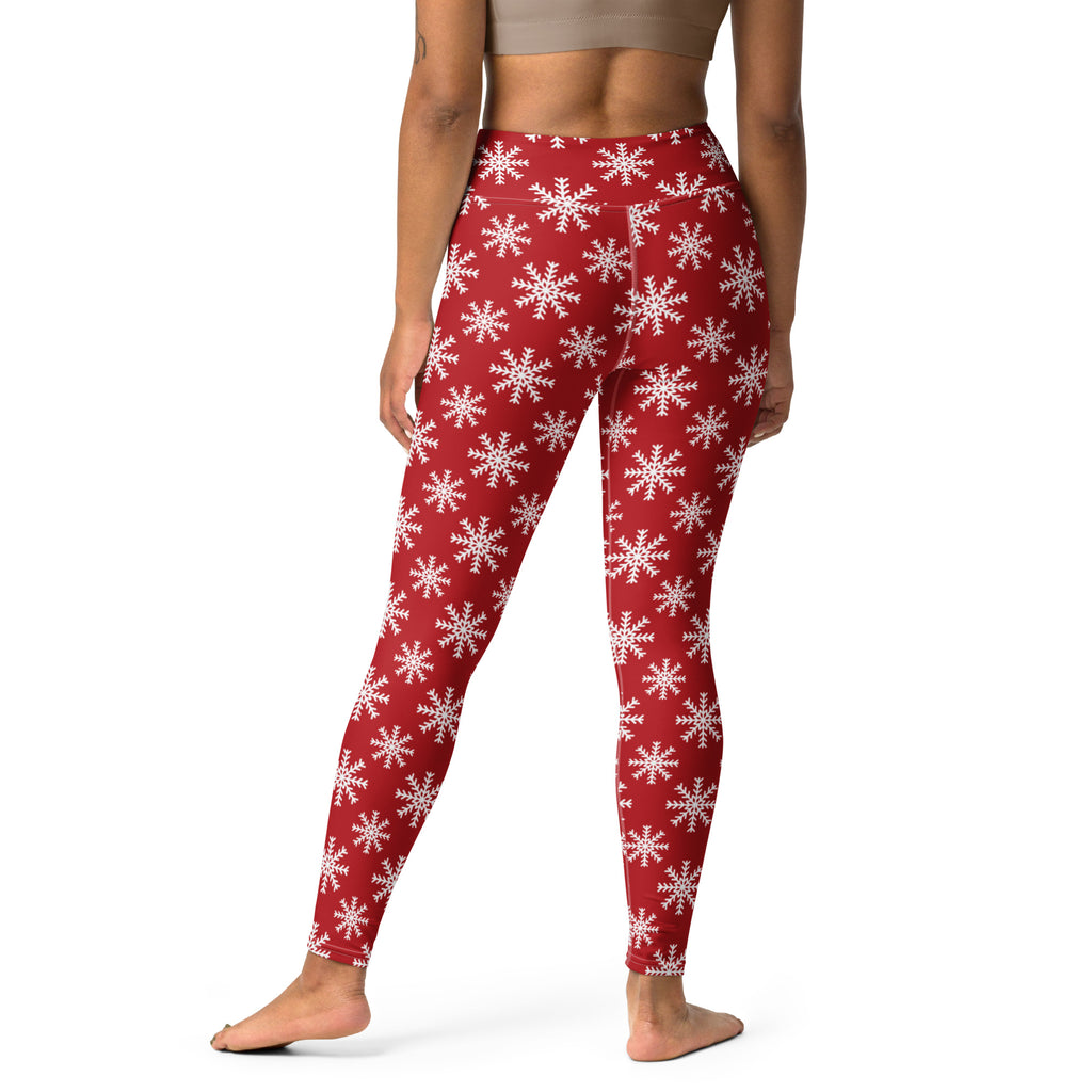 Women’s red buttery soft yoga leggings featuring a white snowflake pattern for festive winter workouts