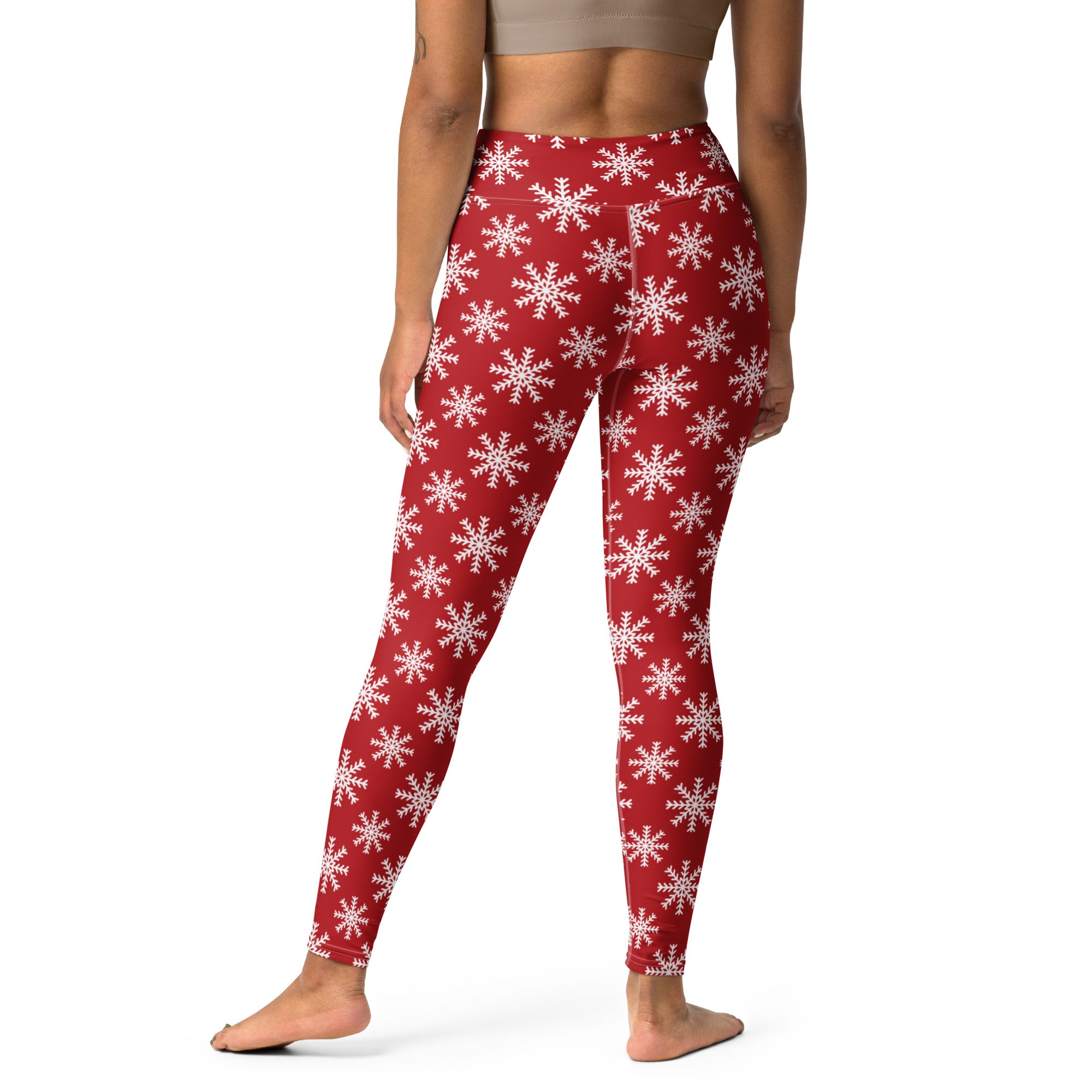 Women’s red buttery soft yoga leggings featuring a white snowflake pattern for festive winter workouts