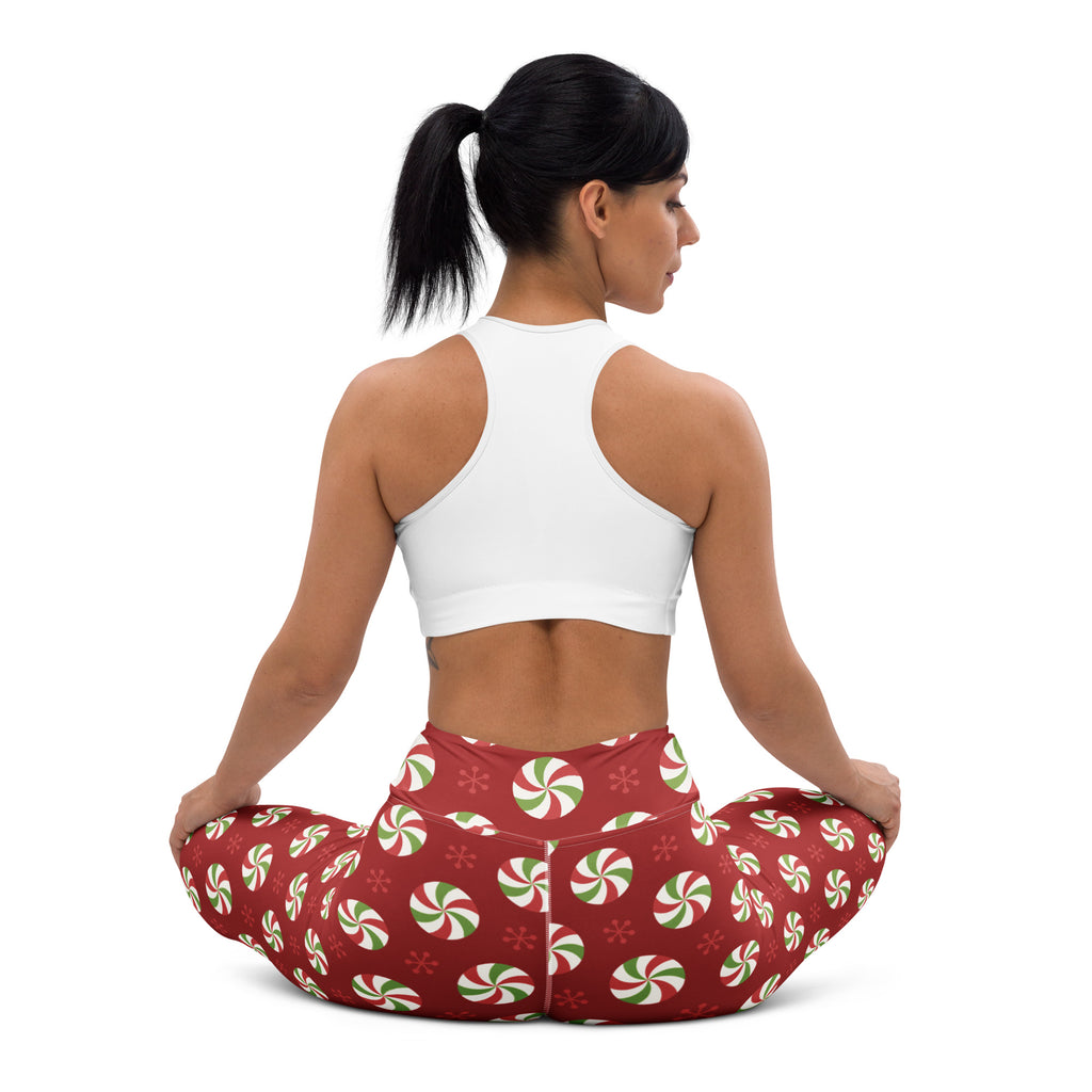Women’s red buttery soft yoga leggings with festive green and white peppermint candy and snowflake pattern