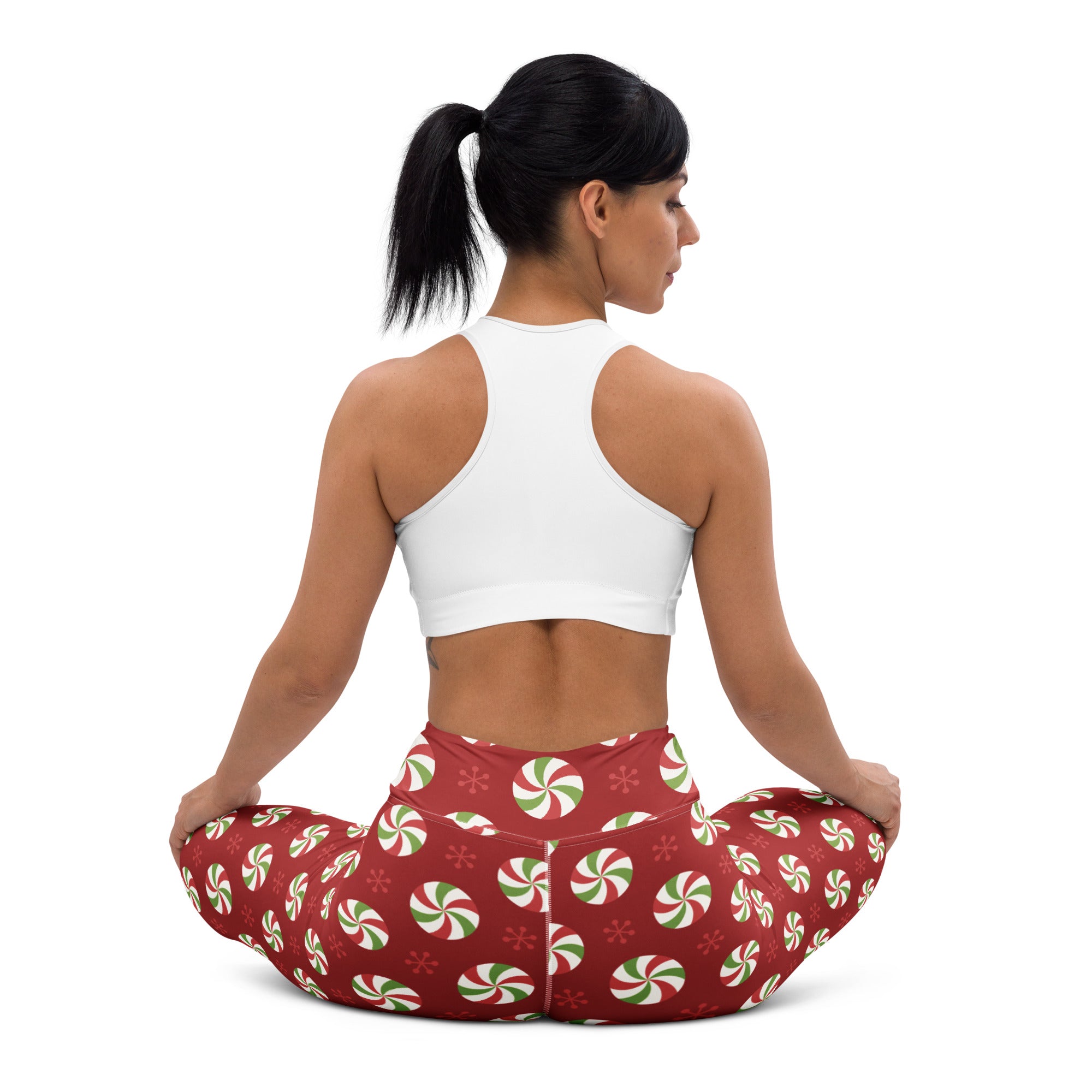 Women’s red buttery soft yoga leggings with festive green and white peppermint candy and snowflake pattern