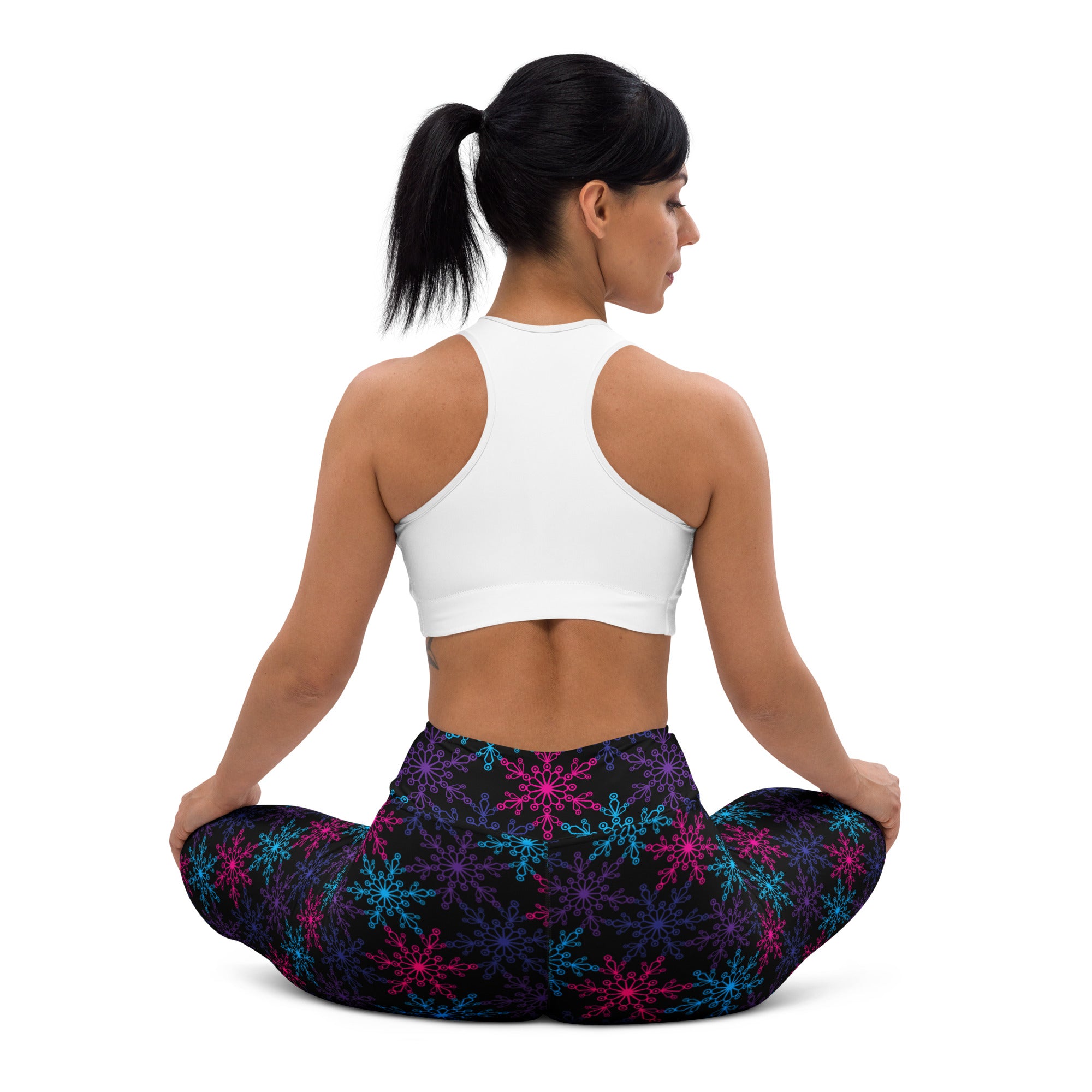 Women’s black buttery soft yoga leggings with vibrant neon pink blue and purple snowflake patterns for winter