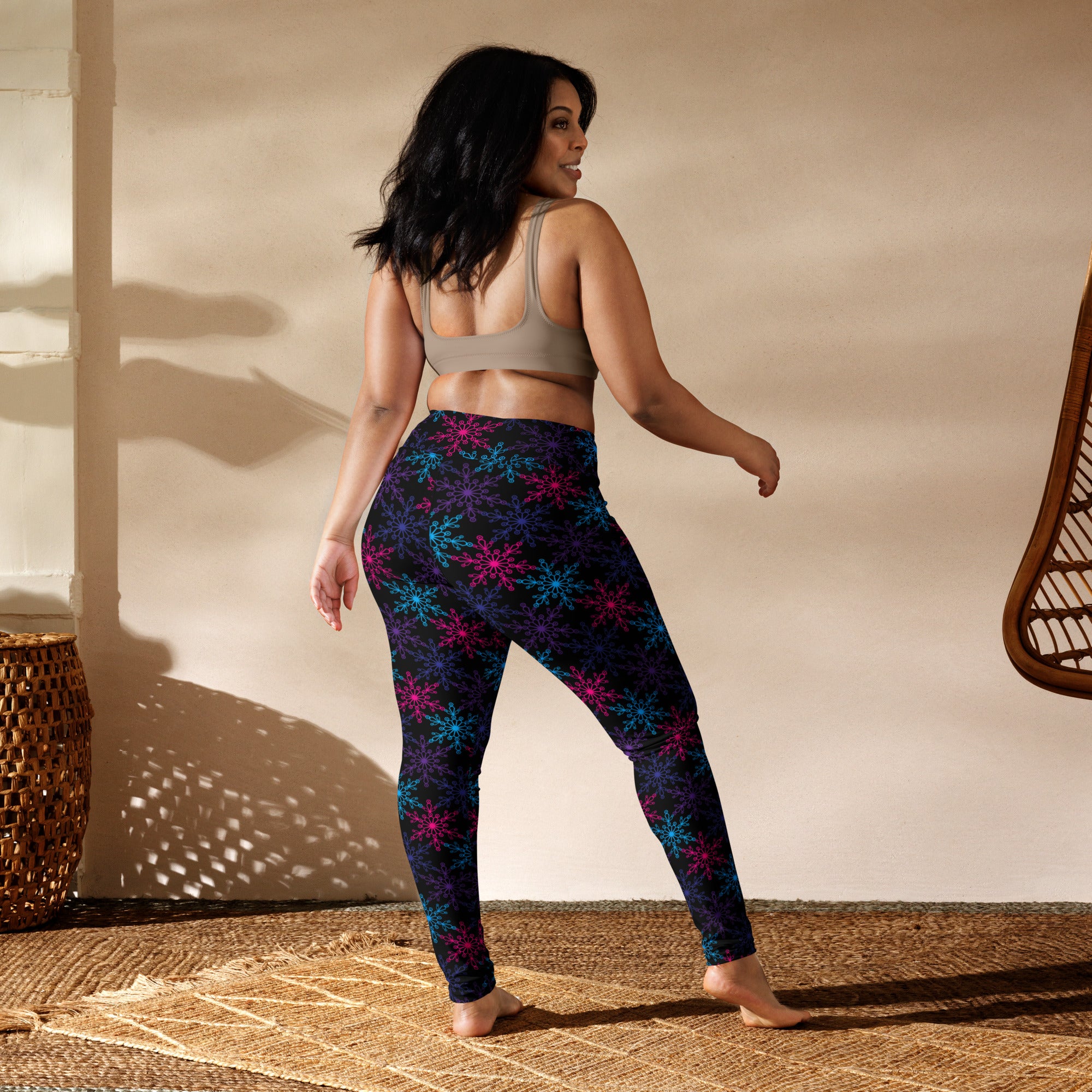 Women’s neon snowflake winter buttery soft yoga leggings in black with glowing pink and blue snowflake pattern