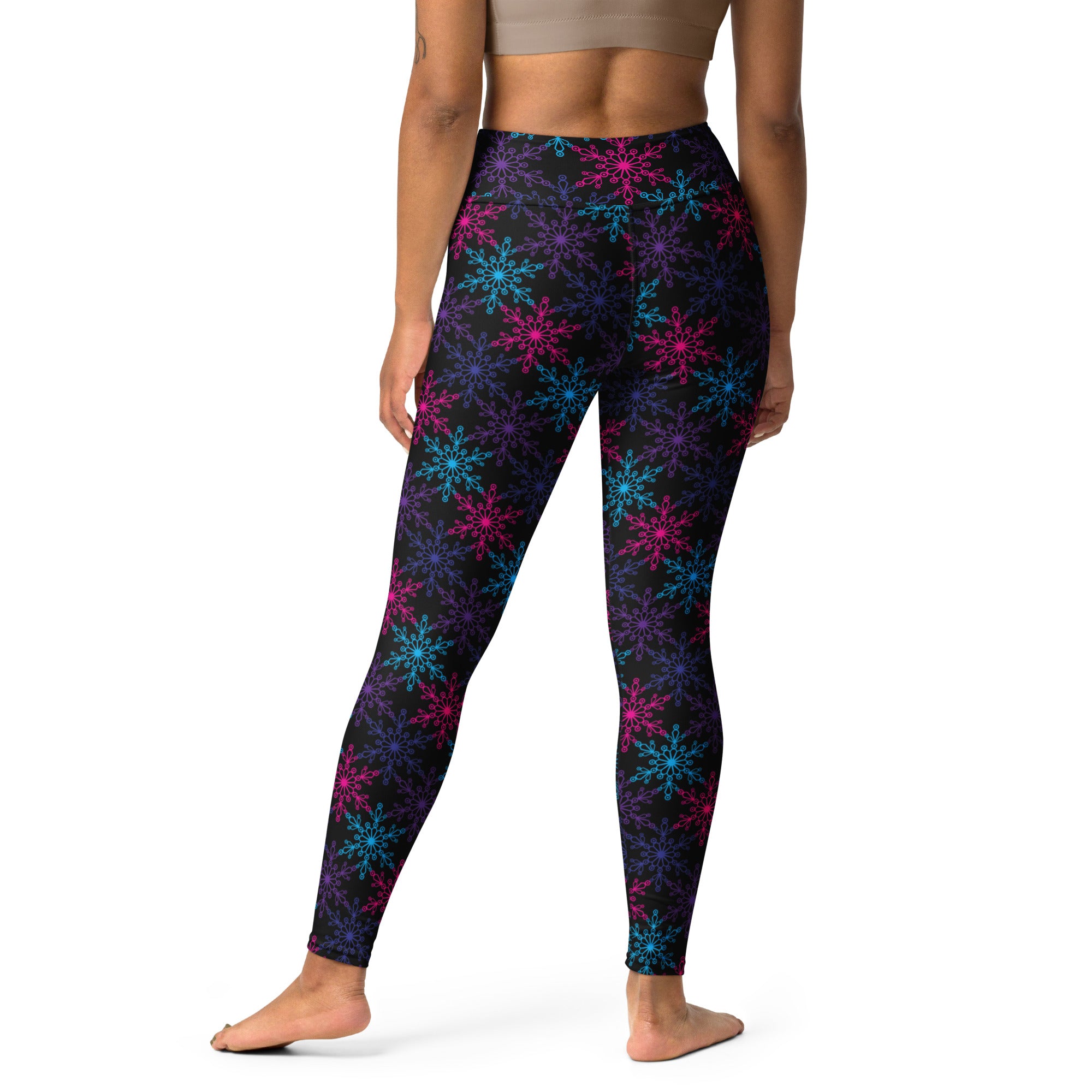 Black women’s buttery soft yoga leggings with vibrant neon pink blue and purple snowflake pattern for winter wear