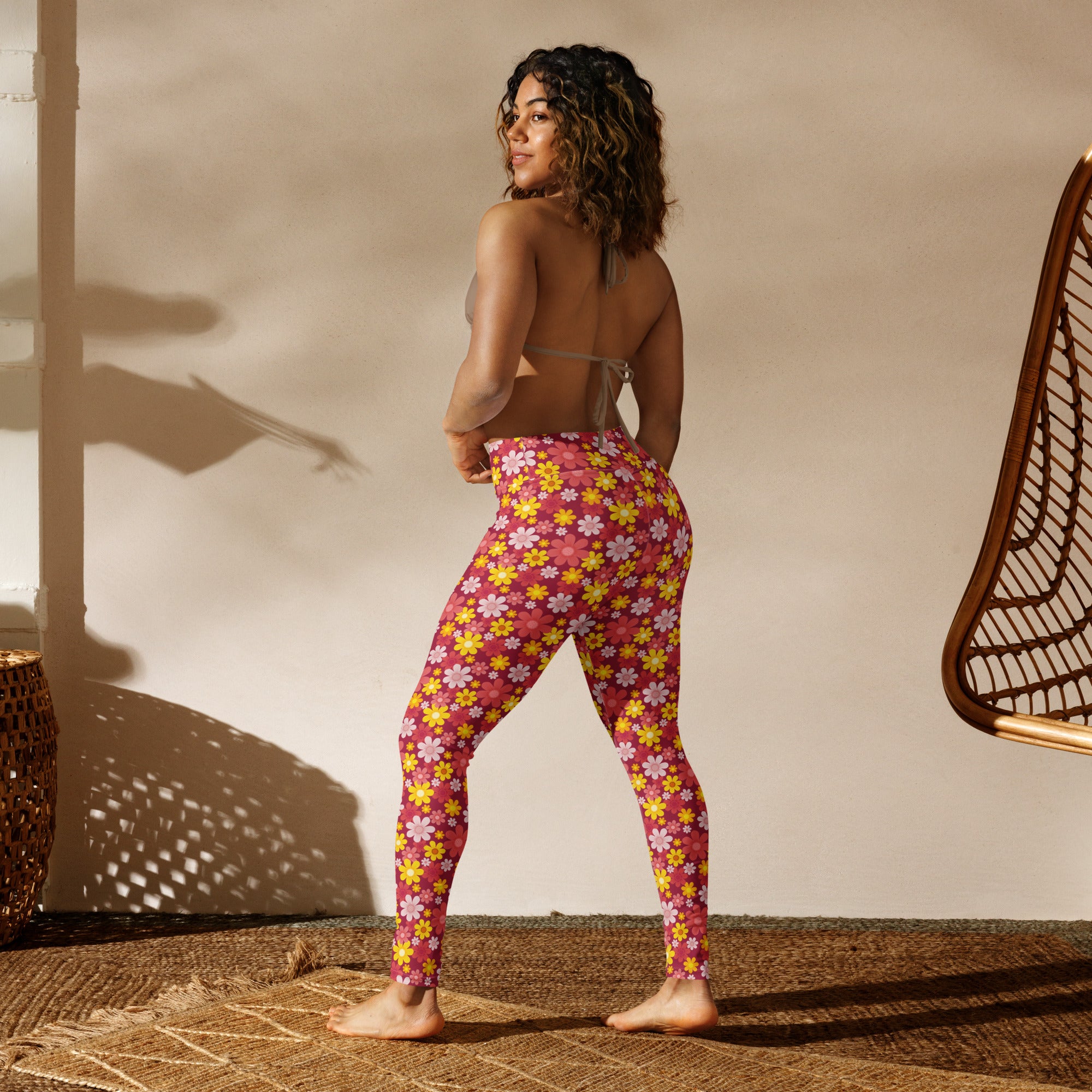 Women’s red floral buttery soft yoga leggings in pink with yellow and white flowers made of stretchy fabric