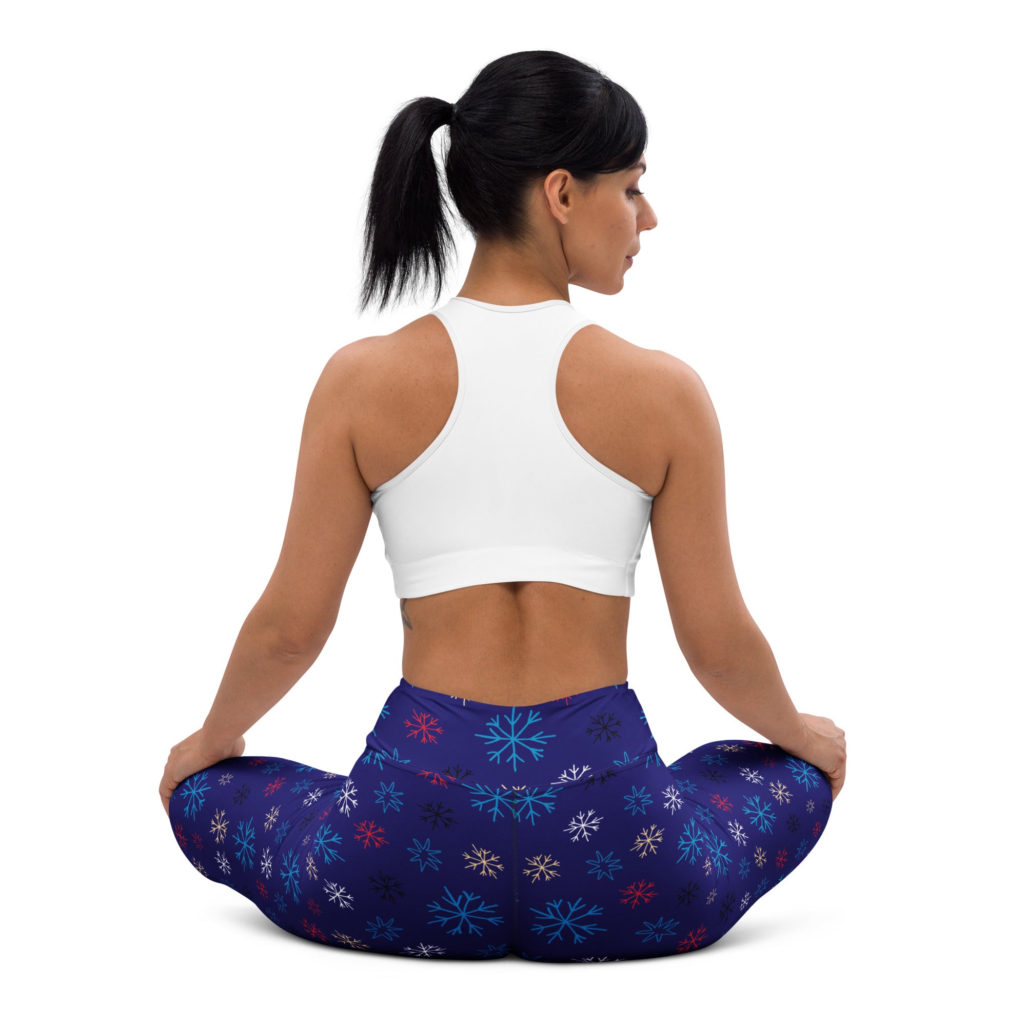 Women’s navy snowflake buttery soft yoga leggings with dark blue fabric and vibrant teal red and white snowflake pattern