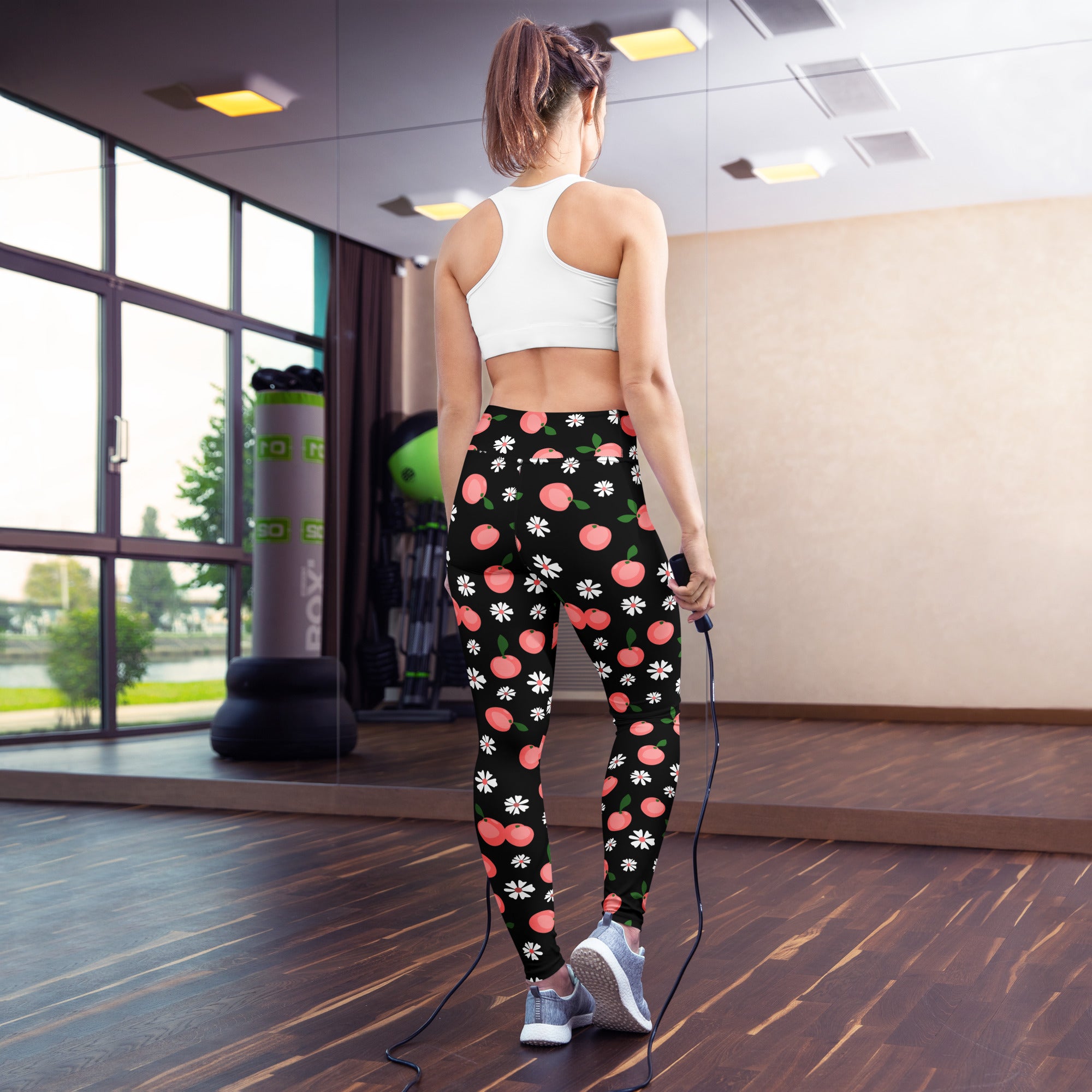 Black buttery soft women’s yoga leggings with playful pink peaches and white daisies floral pattern