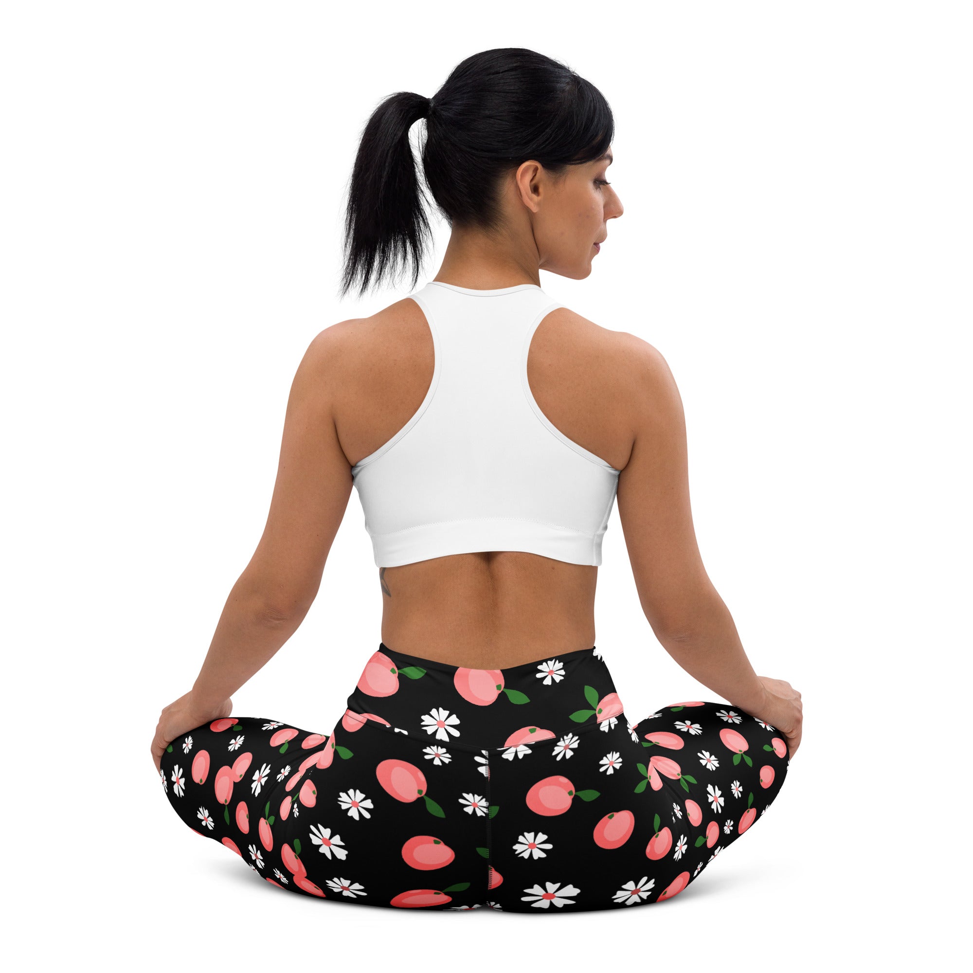 Women’s black buttery soft yoga leggings with a playful pattern of pink peaches and white daisies