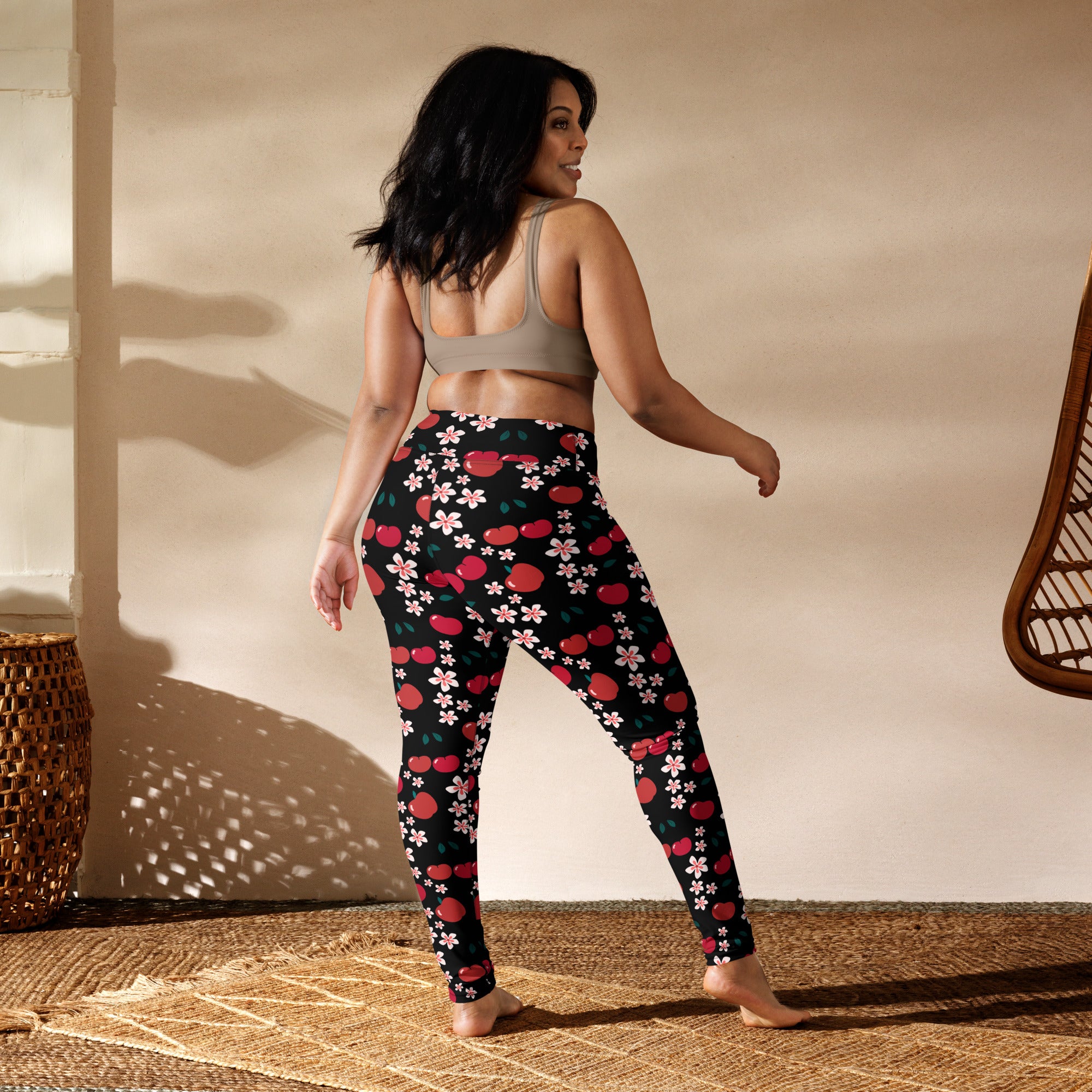 Black buttery soft women’s yoga leggings with vibrant red cherries and pink blossoms pattern