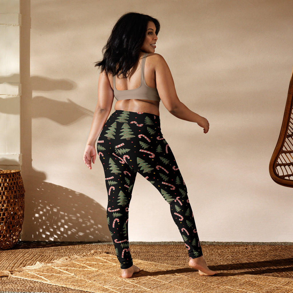 Black women’s buttery soft yoga leggings with festive green pine tree and pink candy cane pattern