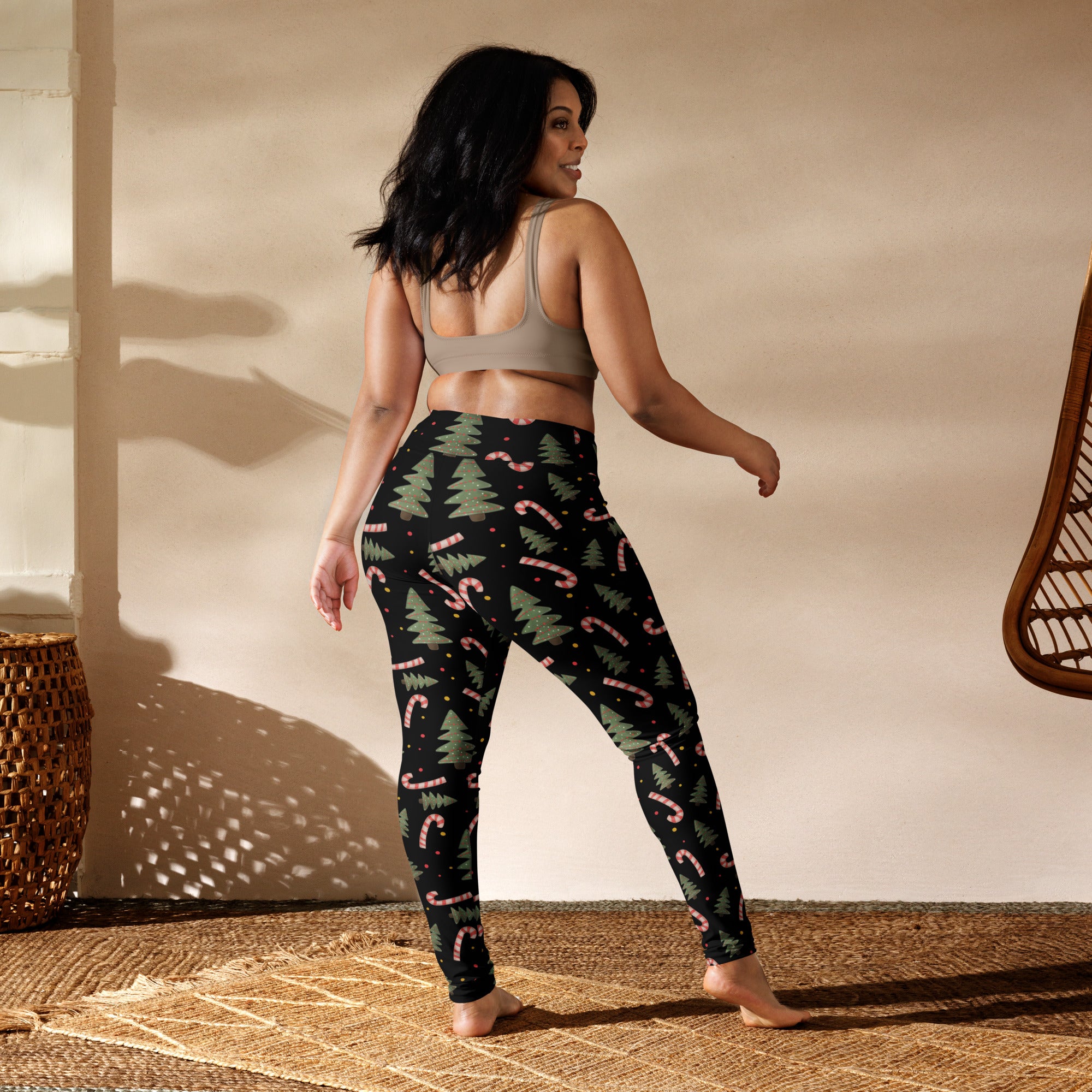 Black women’s buttery soft yoga leggings with festive green pine tree and pink candy cane pattern