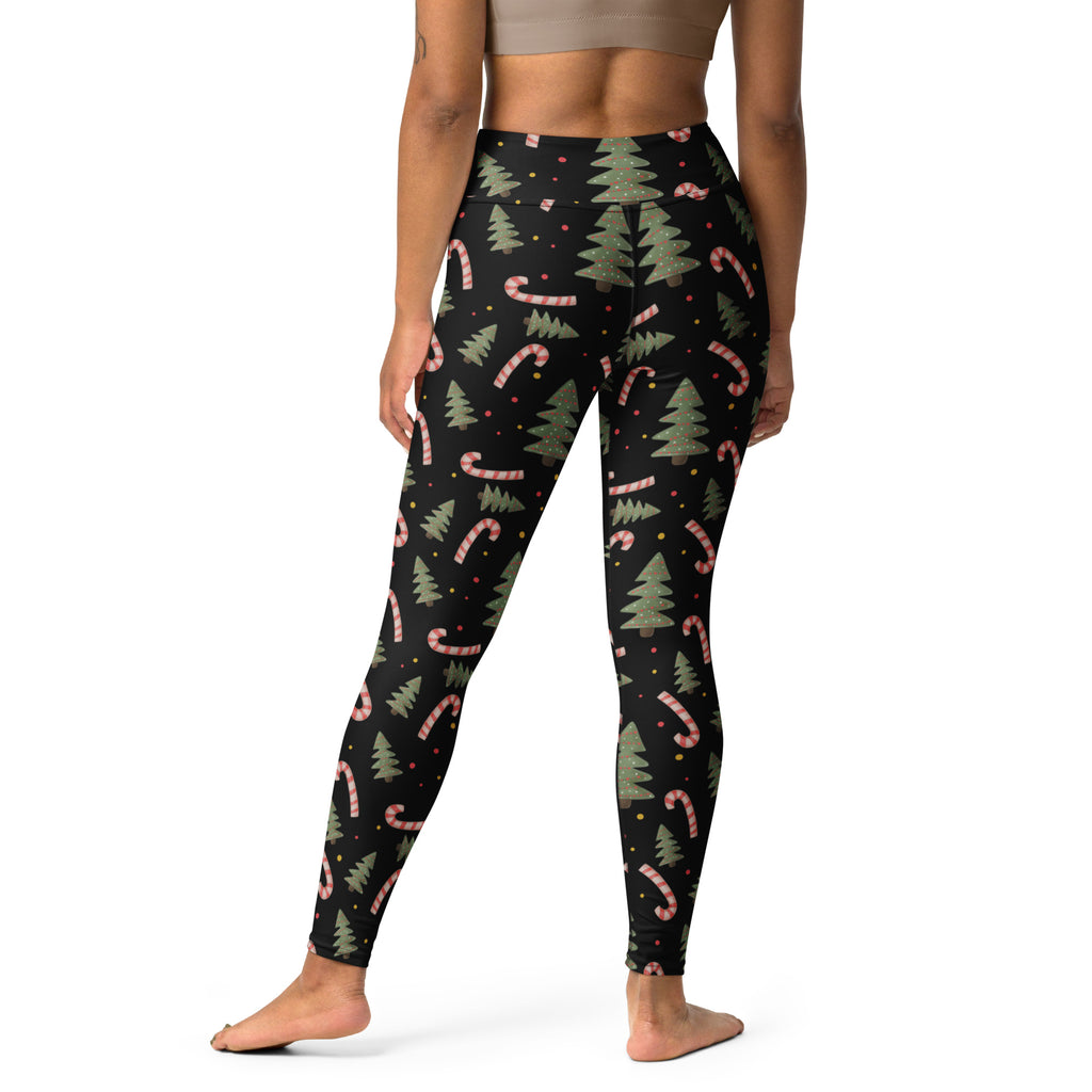 Black women’s buttery soft yoga leggings with festive green pine tree and pink candy cane pattern