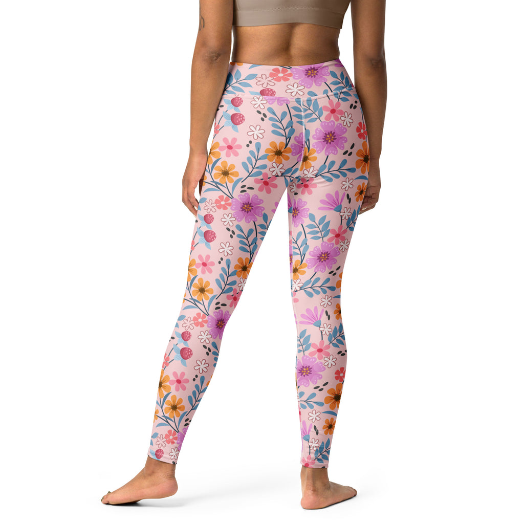 Women’s pink floral buttery soft yoga leggings with vibrant purple orange white flowers and blue leaves pattern