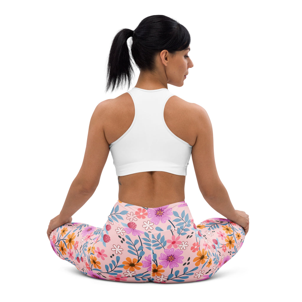 Women’s pink floral buttery soft yoga leggings with vibrant purple orange and blue flower pattern on stretchy fabric