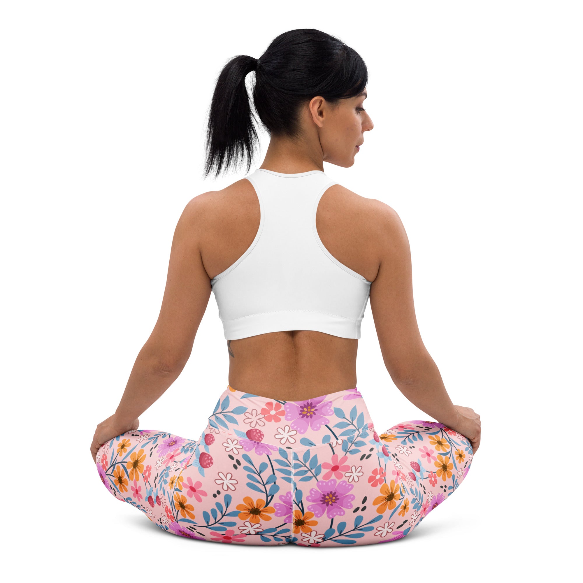 Women’s pink floral buttery soft yoga leggings with vibrant purple orange and blue flower pattern on stretchy fabric