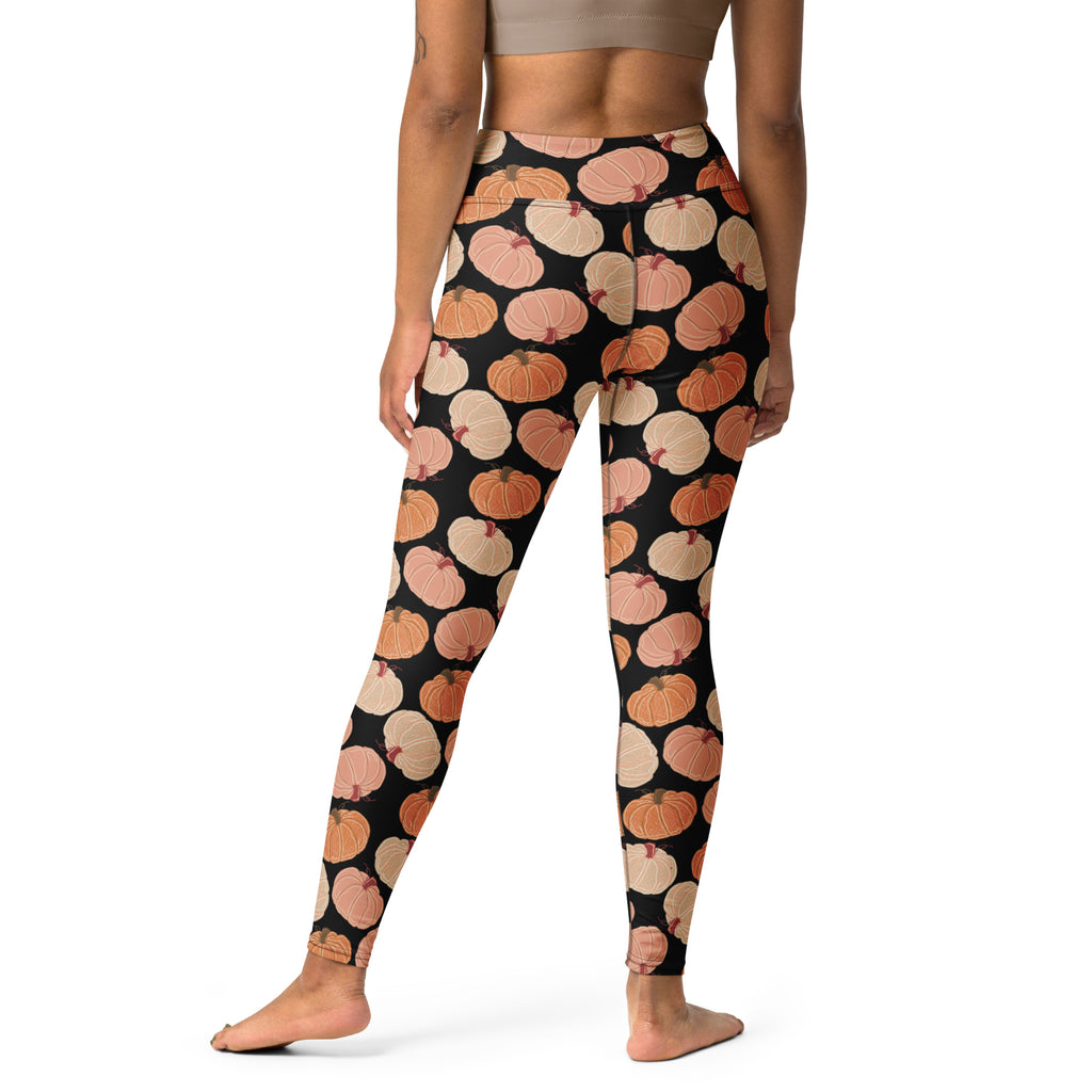 Women’s pumpkin patch buttery soft black leggings with repeating orange and beige pumpkin pattern for yoga