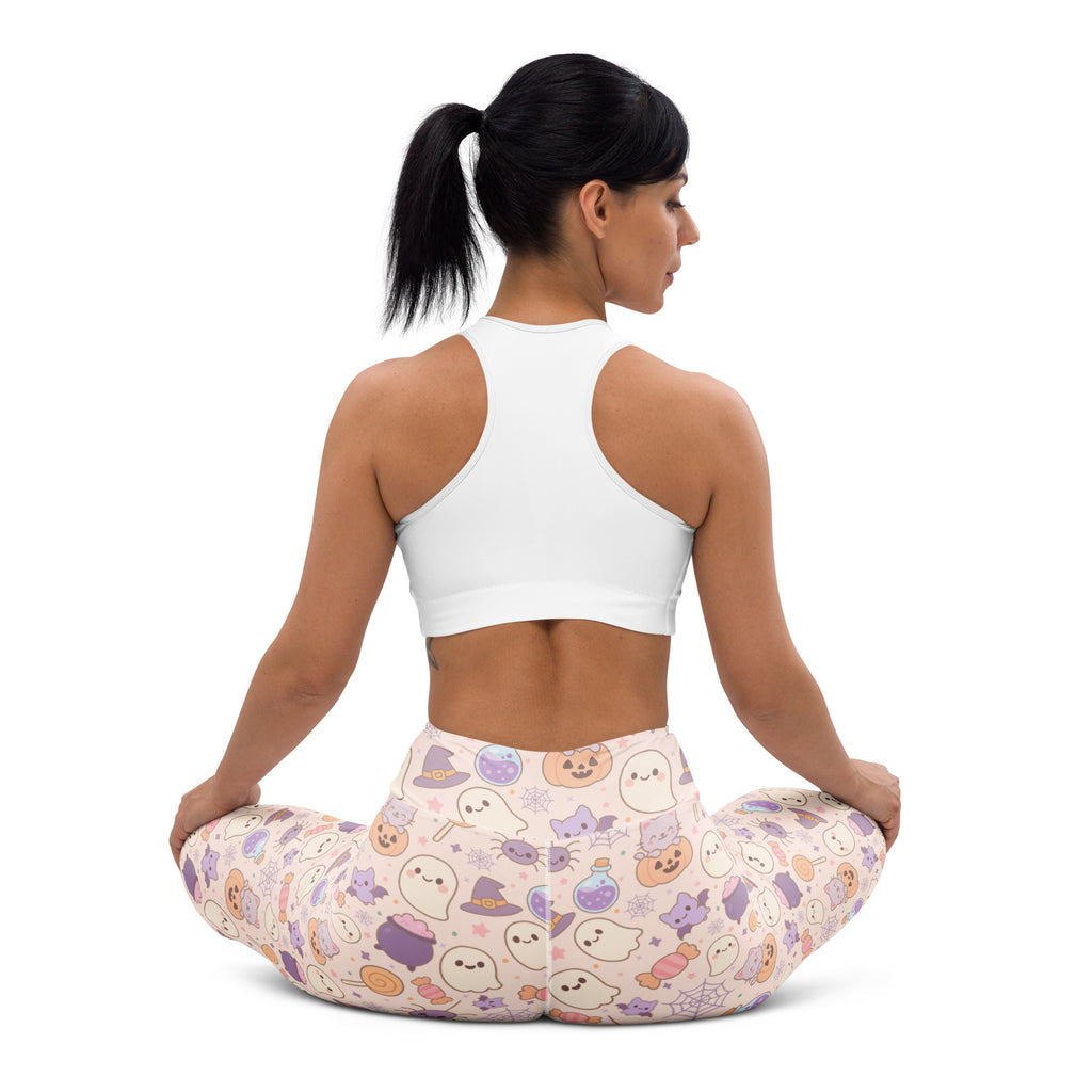 Women’s pastel pink buttery soft yoga leggings with playful halloween pattern featuring ghosts hats pumpkins and candy