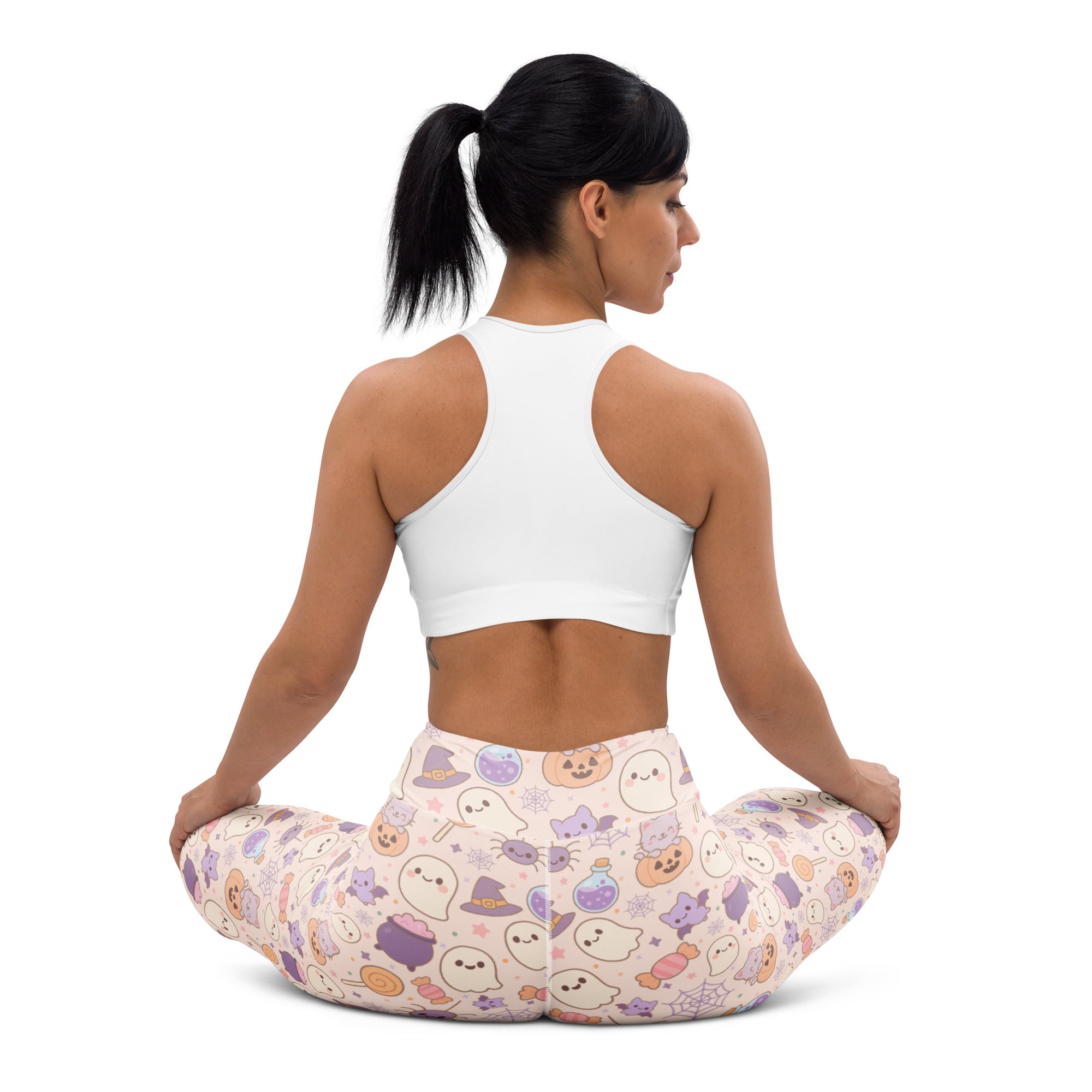 Women’s pastel pink buttery soft yoga leggings with playful halloween pattern featuring ghosts hats pumpkins and candy