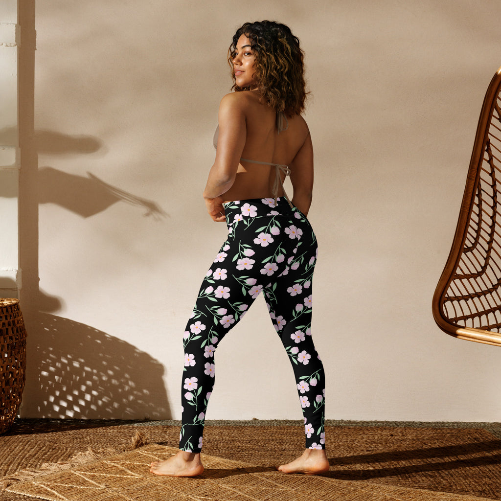 Women’s black buttery soft yoga leggings with a delicate light pink floral and green stem pattern