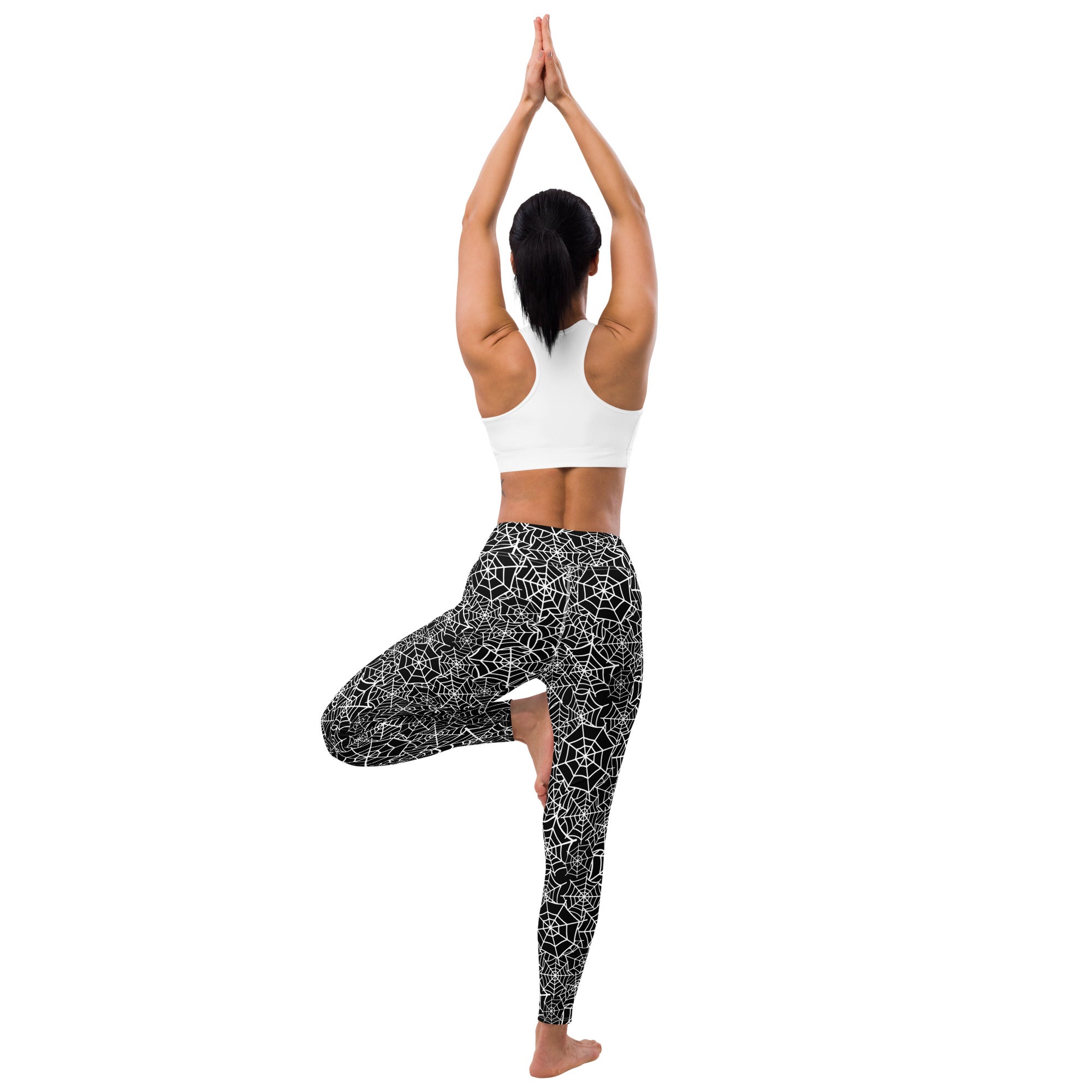 Black buttery soft leggings with white spiderweb pattern designed for women’s Halloween yoga wear