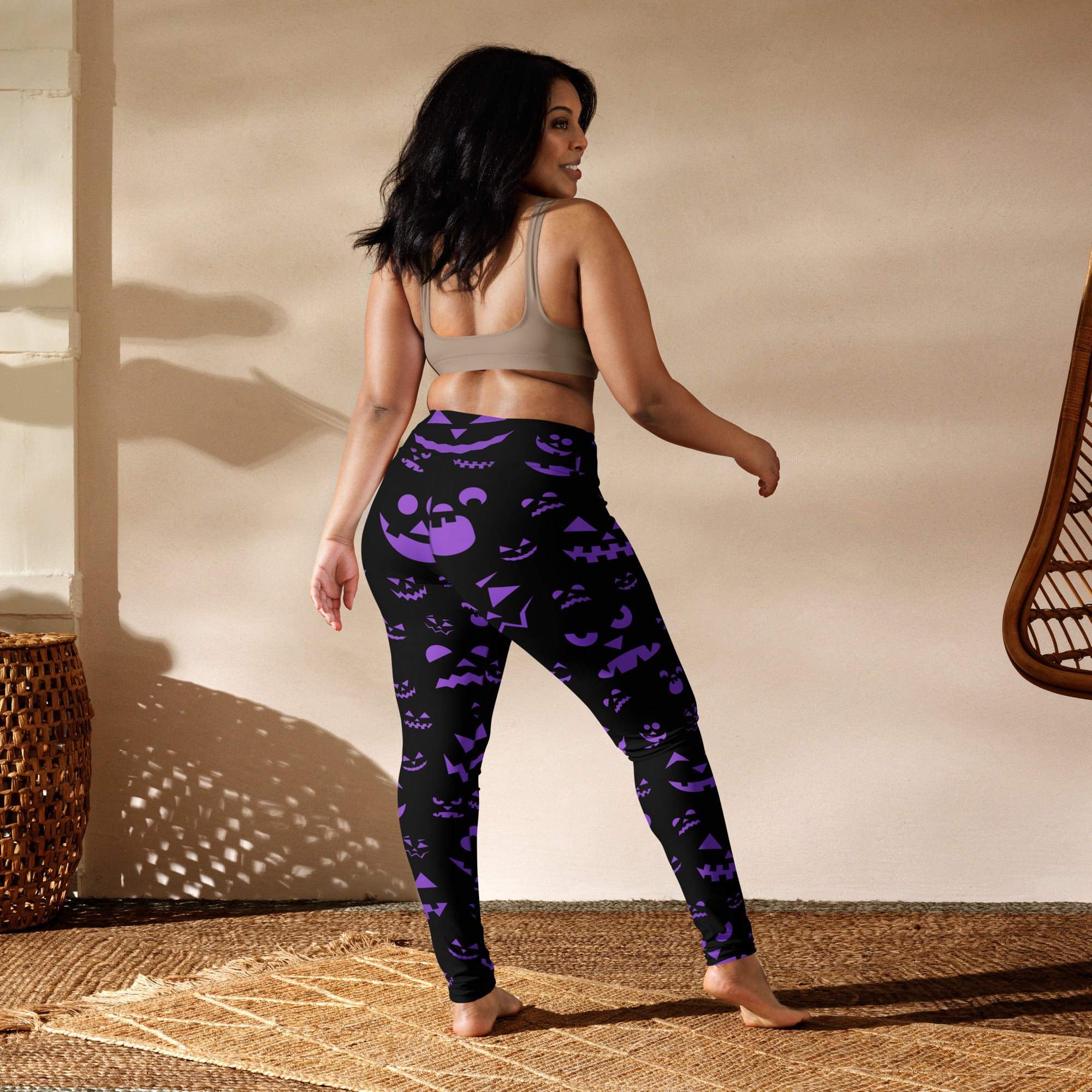 Women’s black leggings with vibrant purple jack-o-lantern faces featuring buttery soft fabric for halloween yoga