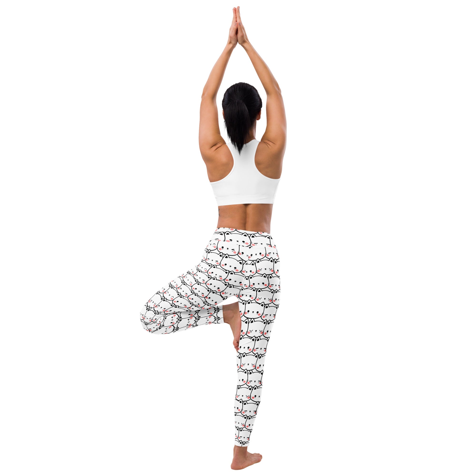 White buttery soft women’s yoga leggings with a repeating pattern of cute cat faces outlined in black and pink accents
