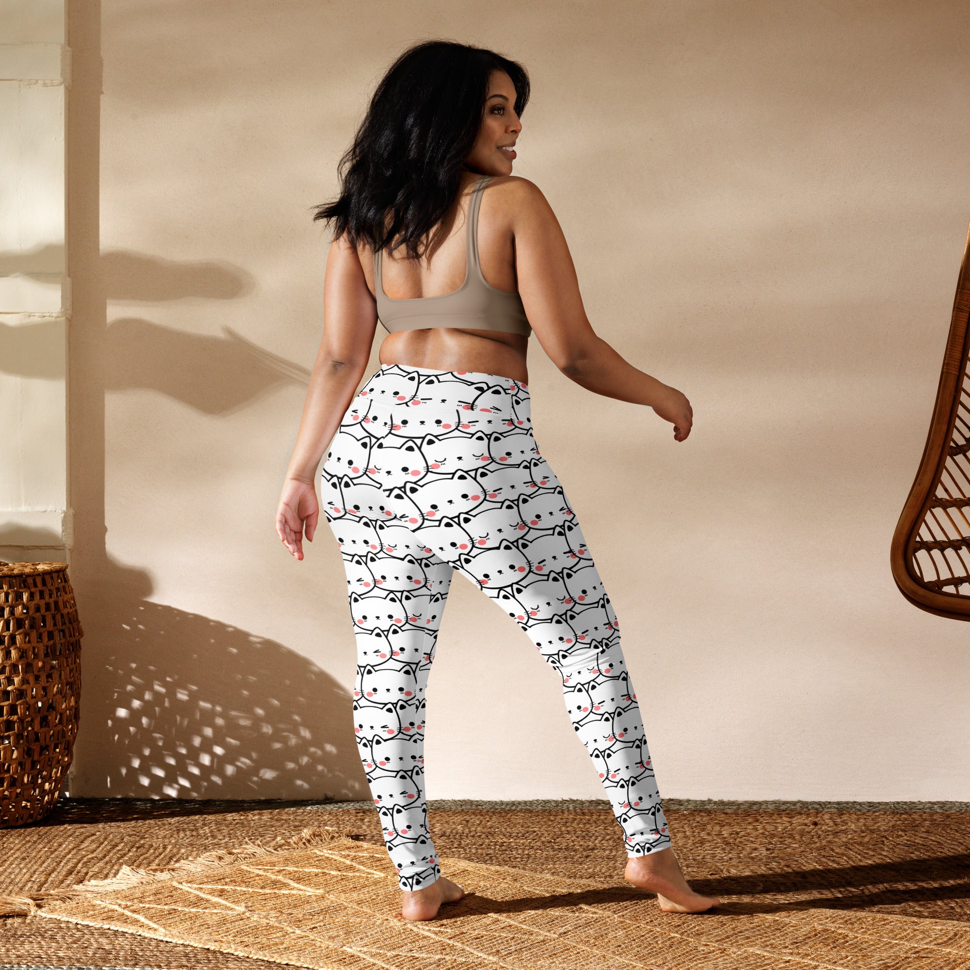 White buttery soft women’s yoga leggings with black outlined cat face pattern and pink accents