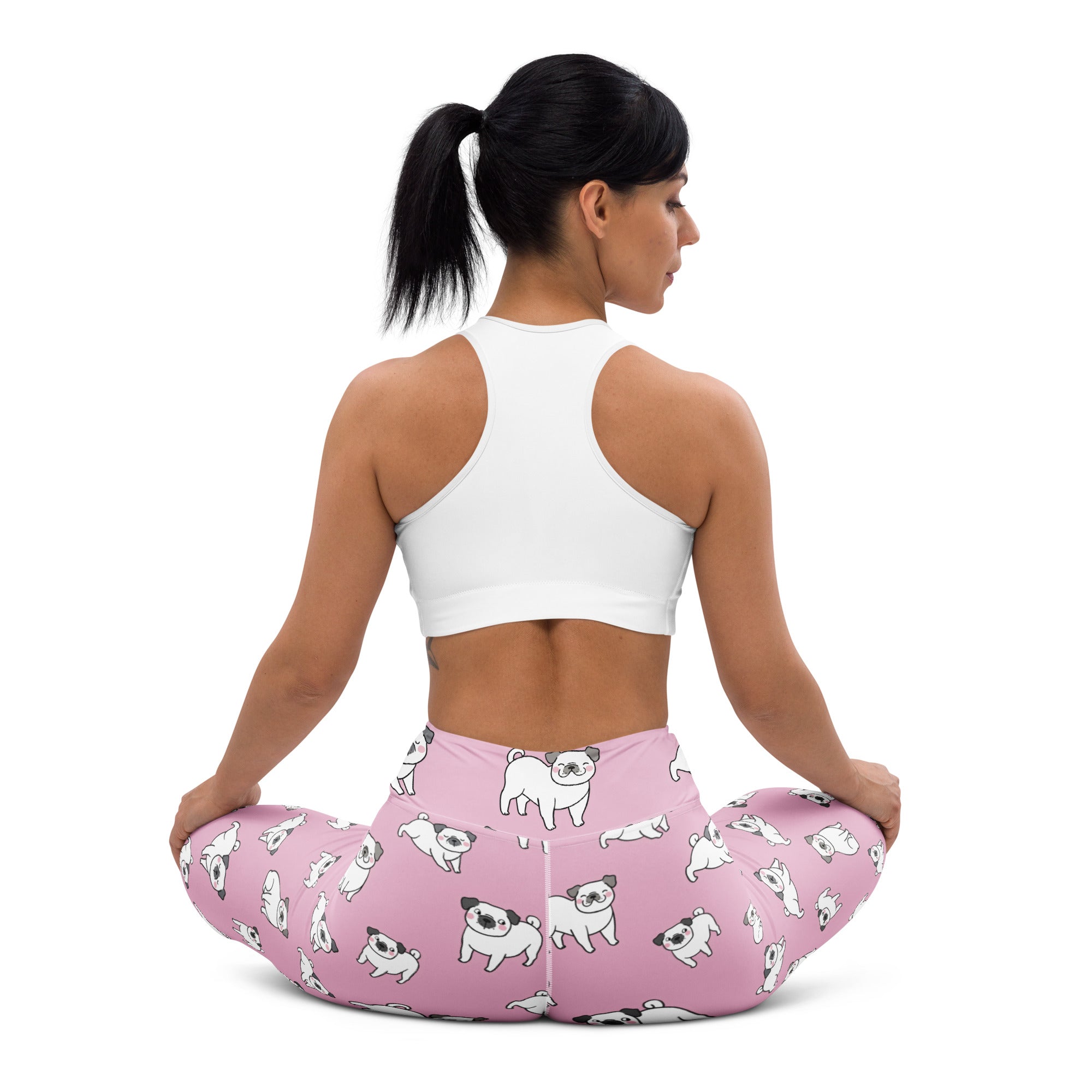 Women’s pink buttery soft yoga leggings with a playful pattern of white and black pug dogs