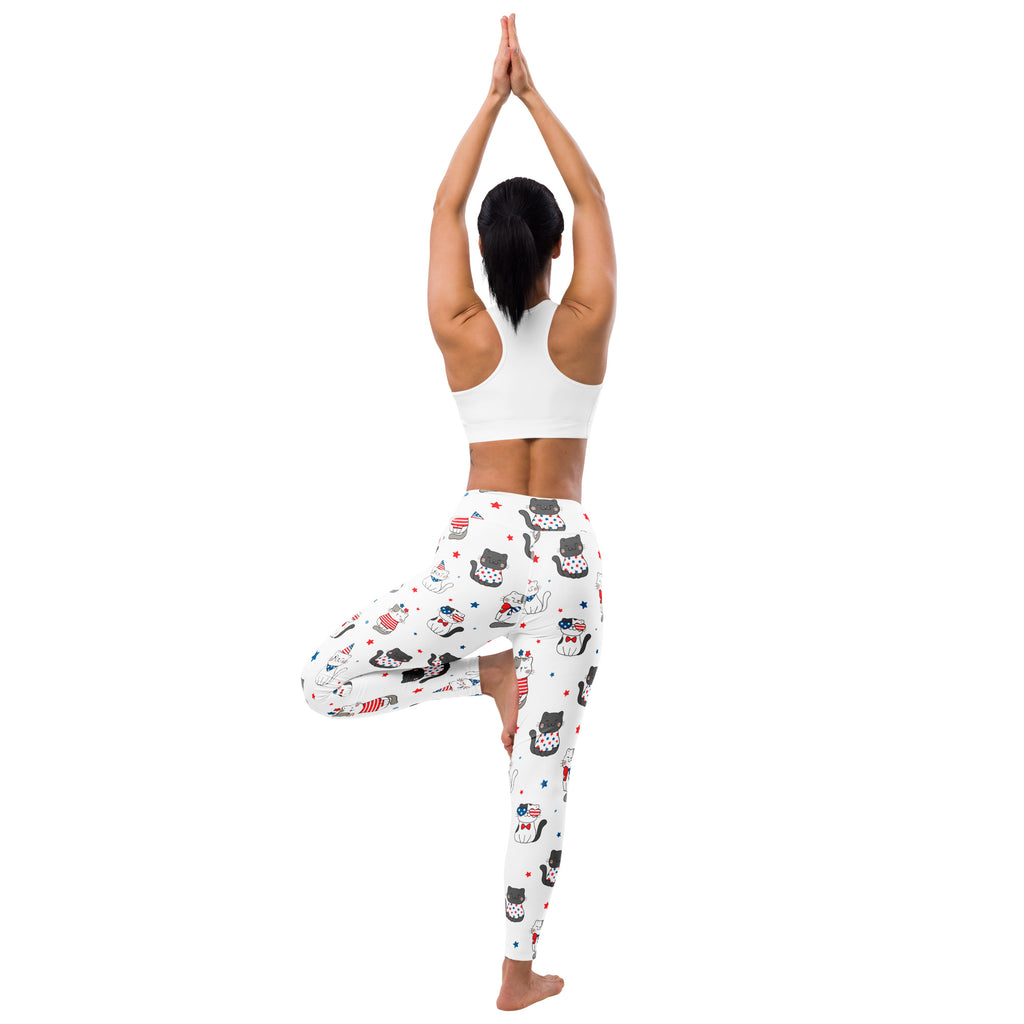 White buttery soft women’s yoga leggings with black cats wearing american flag accessories and scattered stars pattern