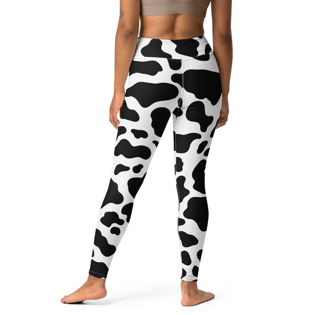 Women’s high-waisted cow print buttery soft yoga leggings in black and white with a comfortable fit