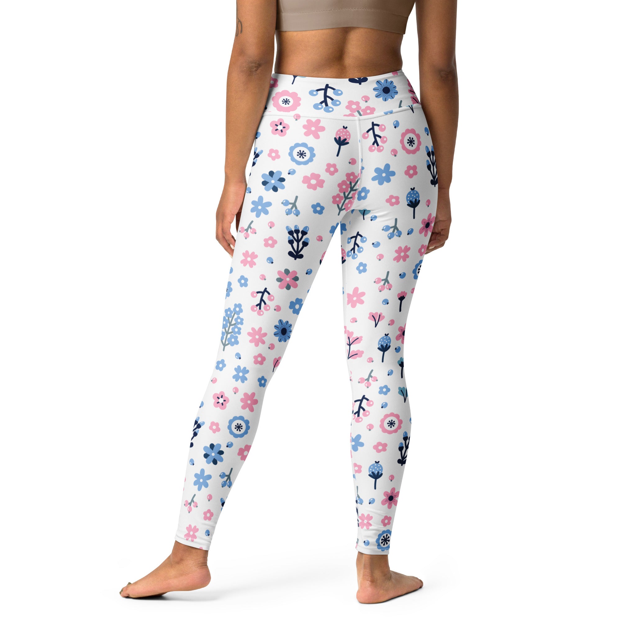 White high-waisted buttery soft yoga leggings with a playful pink and blue floral pattern and black stems