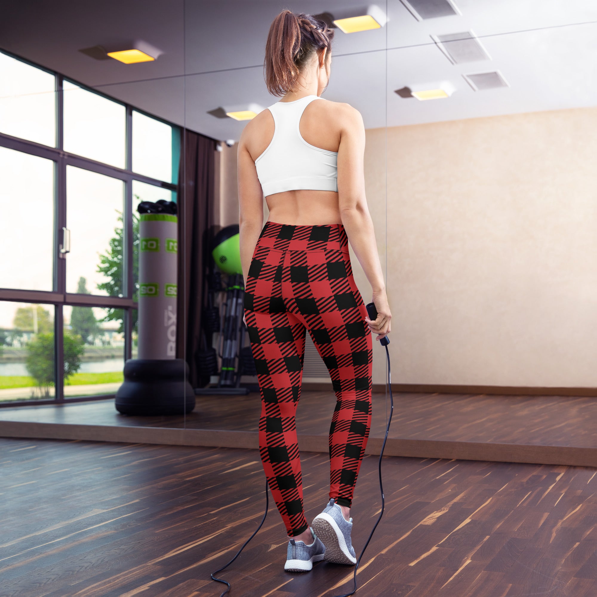 Women’s red buffalo plaid buttery soft yoga leggings in red and black shown from the back side
