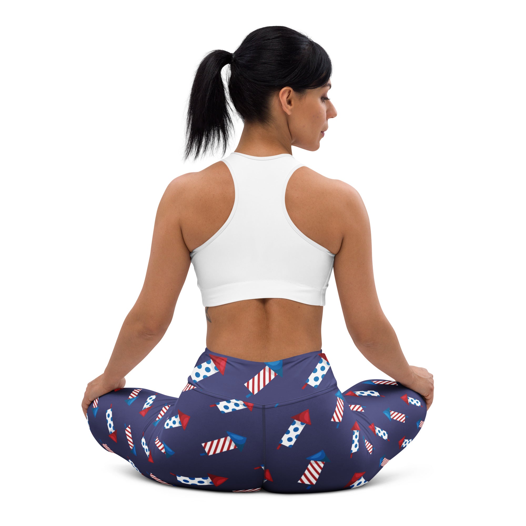 Navy blue buttery soft women’s yoga leggings with a playful red white and blue firework pattern for 4th of July