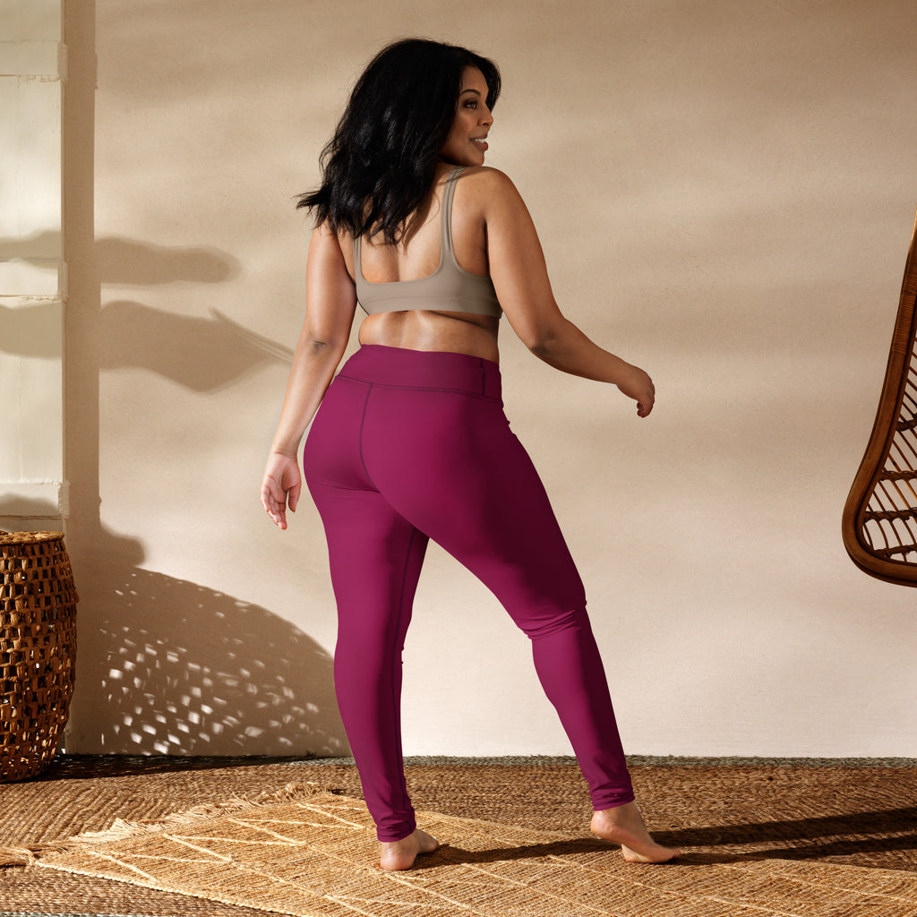 A pair of women’s dark magenta high-waisted buttery soft yoga leggings made from stretchy athletic fabric