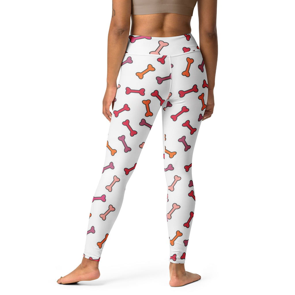 White high-waisted women’s buttery soft yoga leggings with colorful pink red and orange dog bone pattern