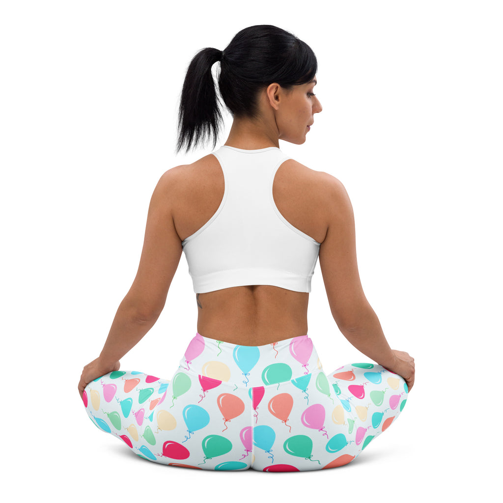 White buttery soft women’s yoga leggings with colorful birthday balloon pattern in pink blue green and orange