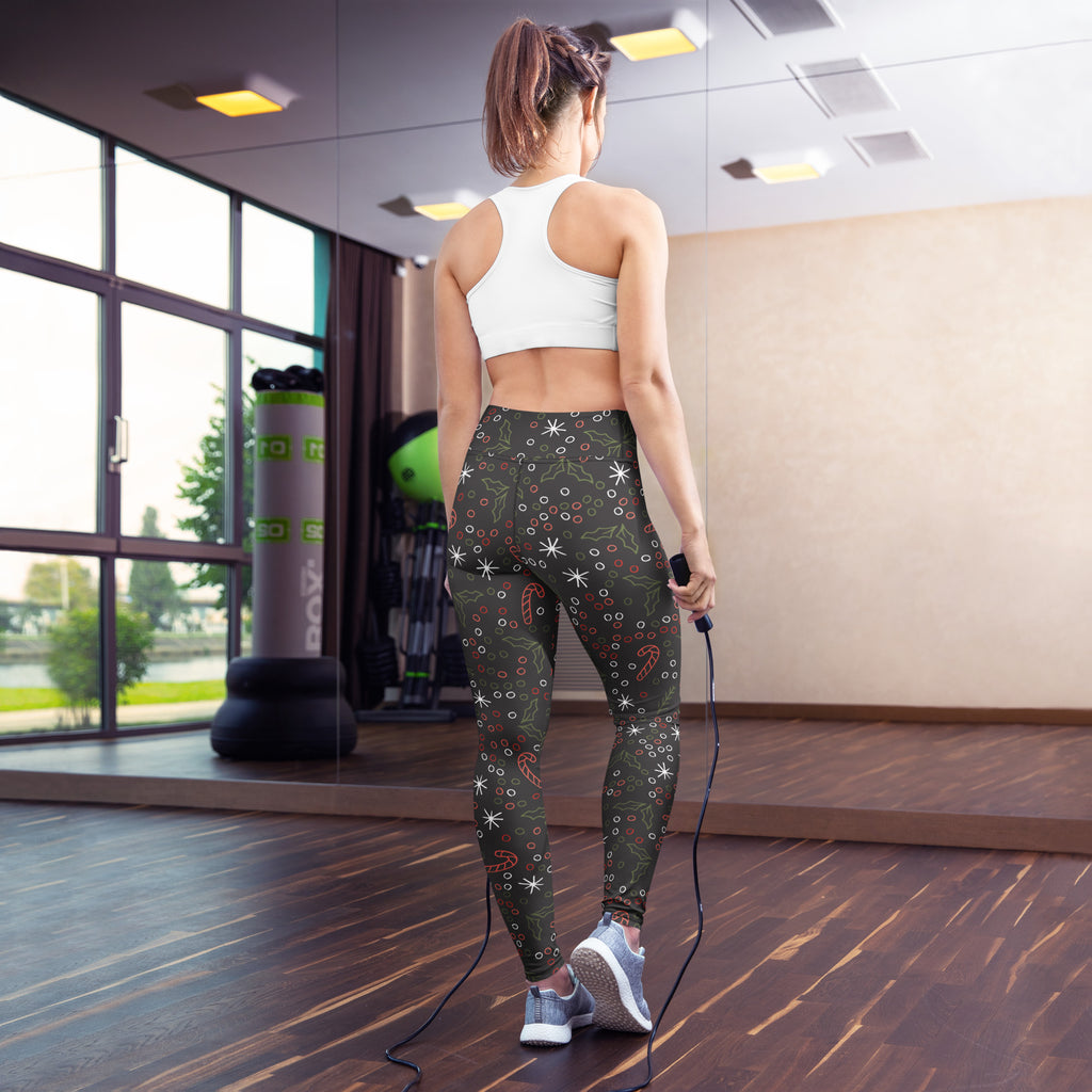 Women’s dark gray buttery soft yoga leggings with festive white stars red candy canes and holly leaf pattern