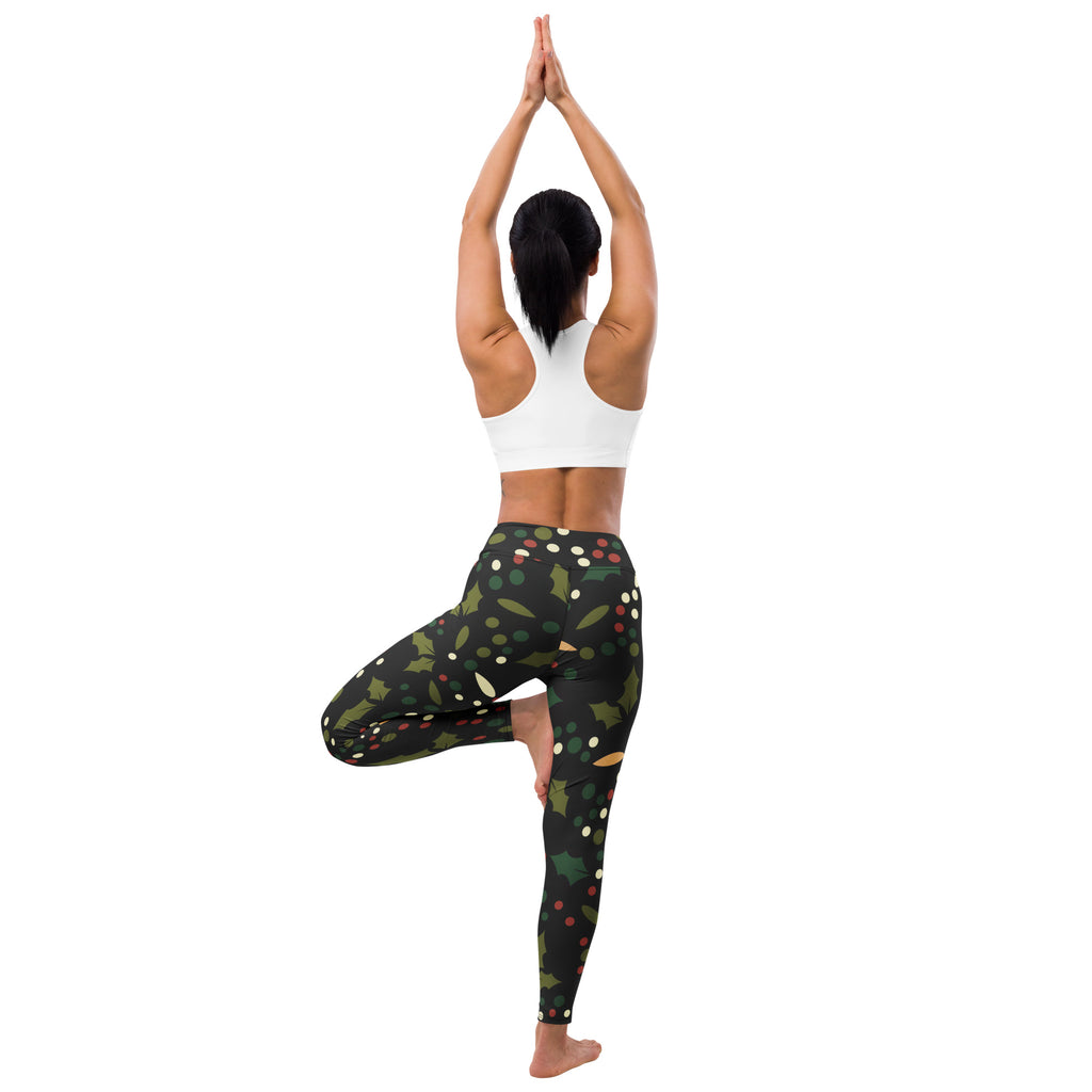 Women’s black buttery soft yoga leggings with festive holly berry pattern in green white red and gold accents